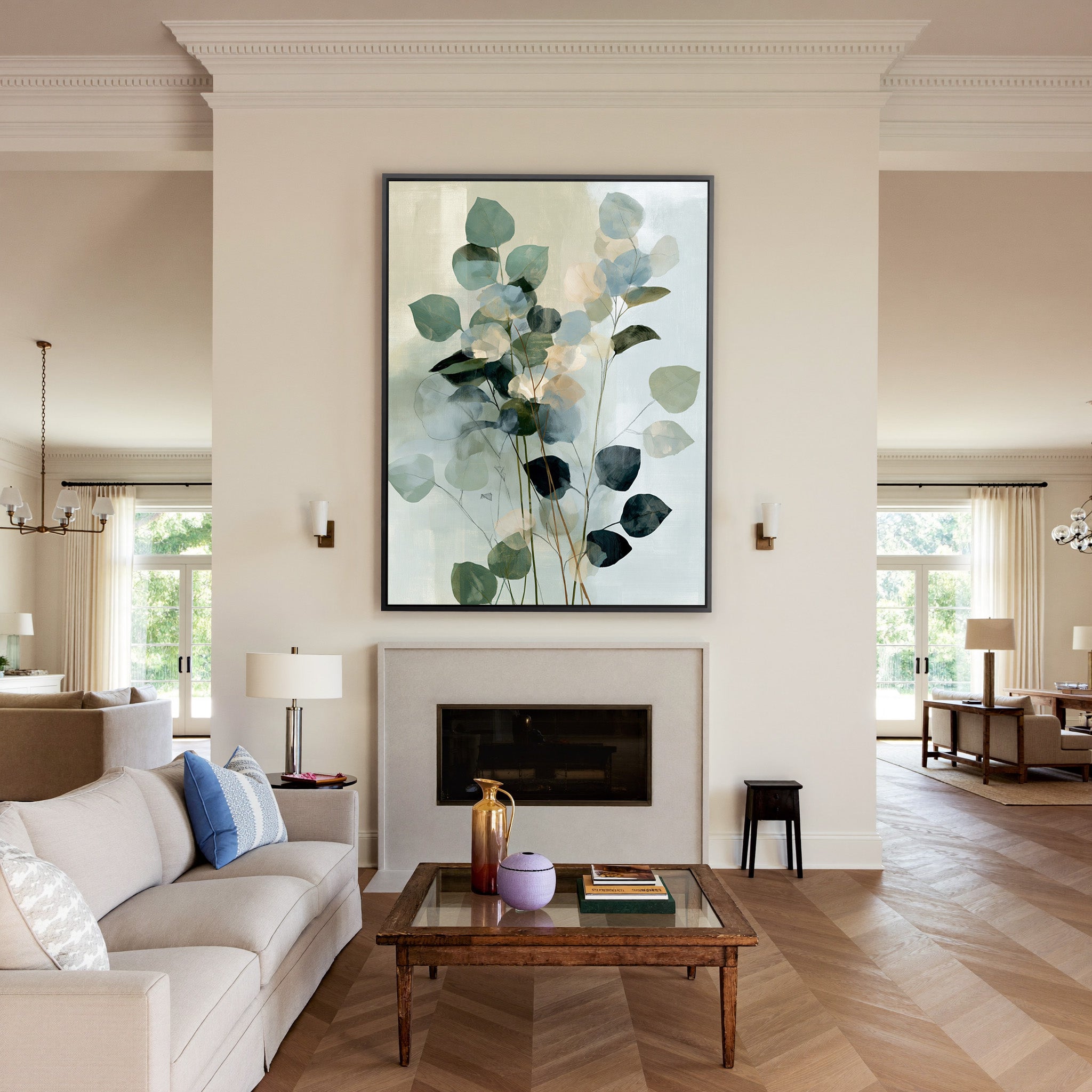 soft eucalyptus like leaves in blue green and canvas wall art in a black frame above a mantel
