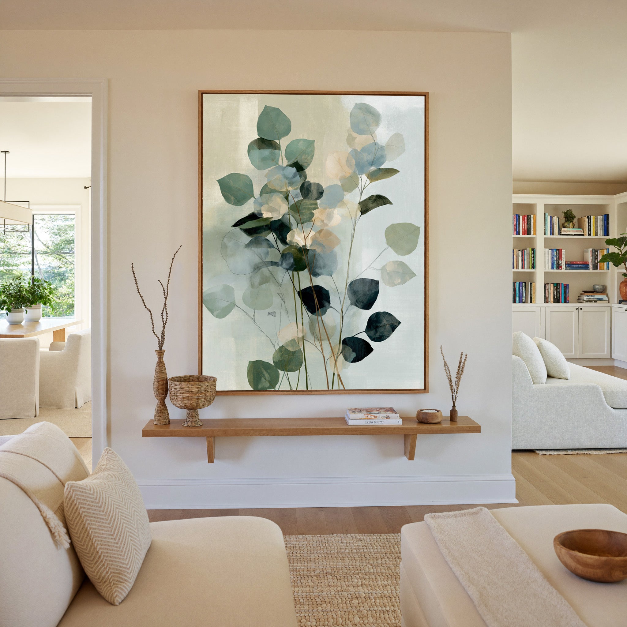 soft eucalyptus like leaves in blue green and canvas wall art in an oak frame in a living room