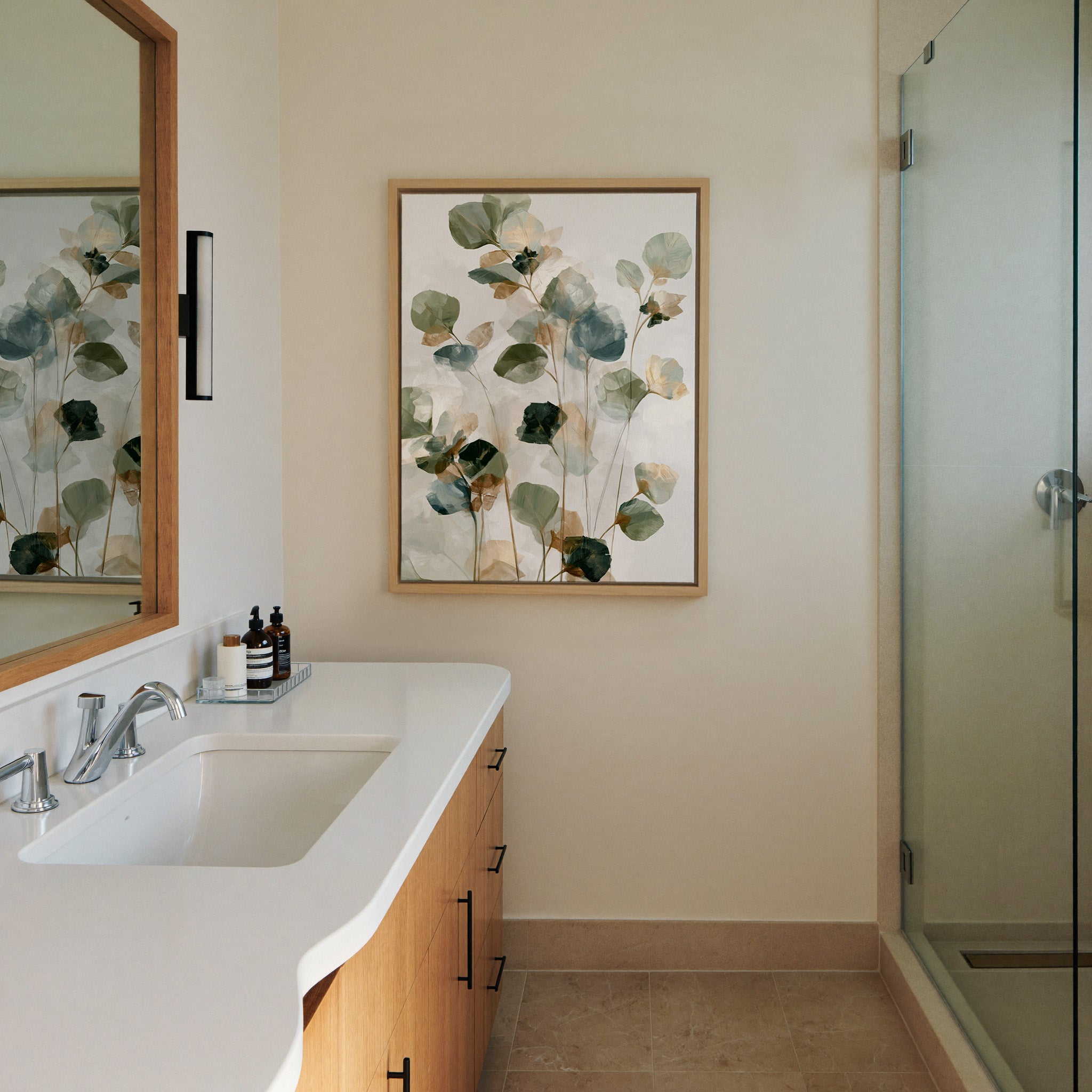soft eucalyptus like leaves in canvas wall art in a natural wood frame in a styled room setting