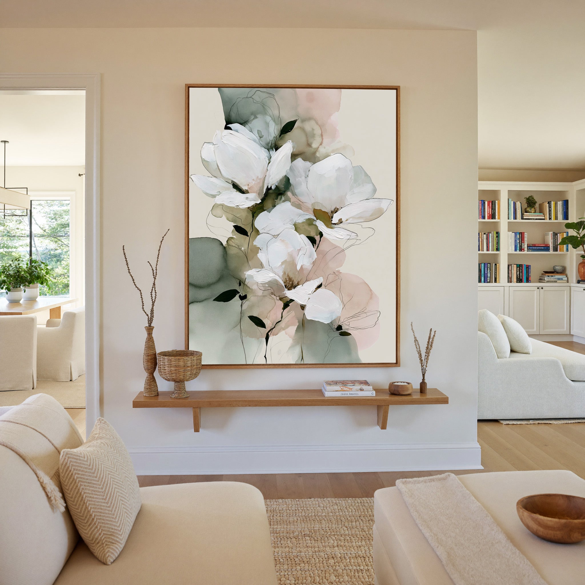 white magnolia like blooms with sage and blush canvas wall art in an oak frame in a living room