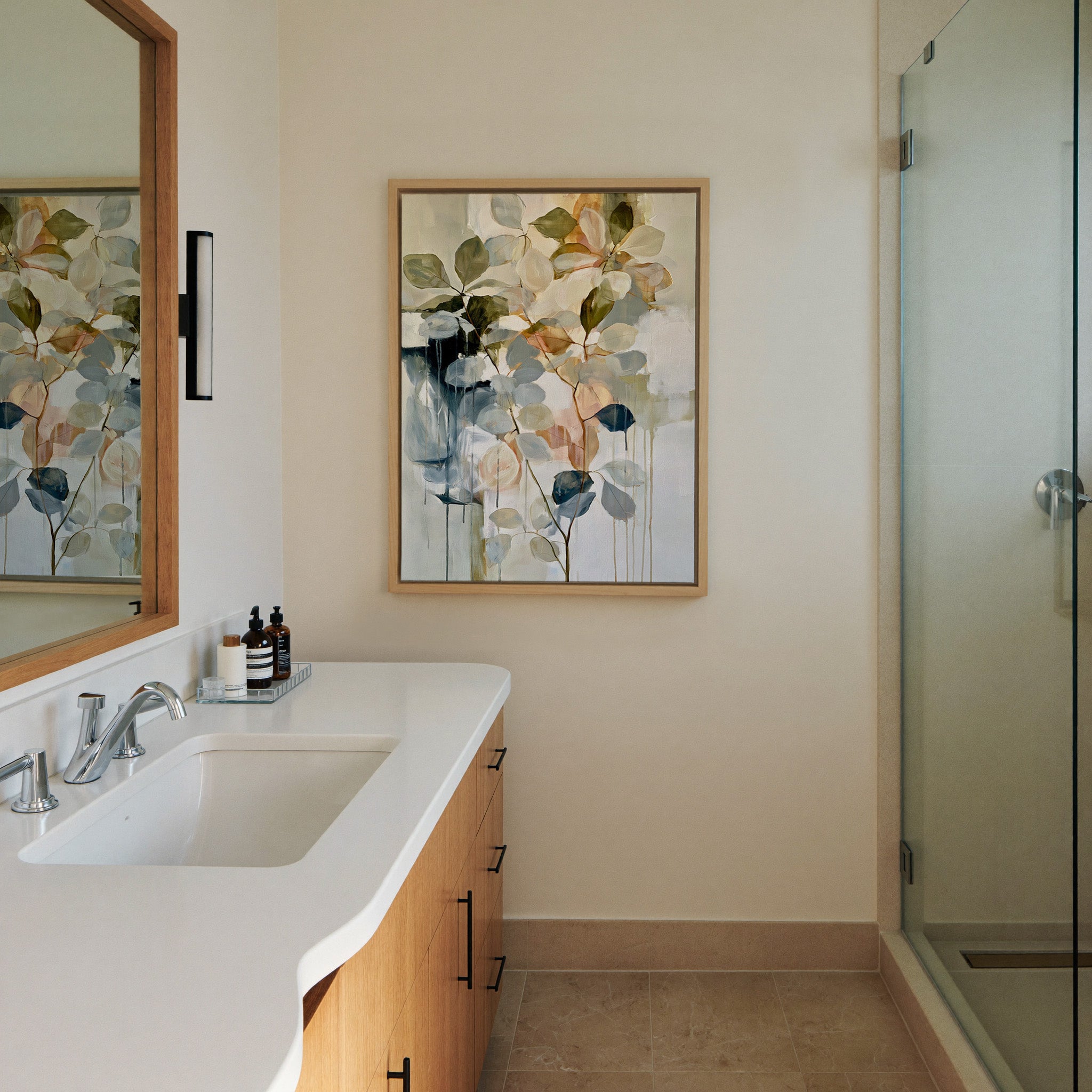 soft eucalyptus like leaves in cream, sage, canvas wall art in a natural wood frame in a styled room setting