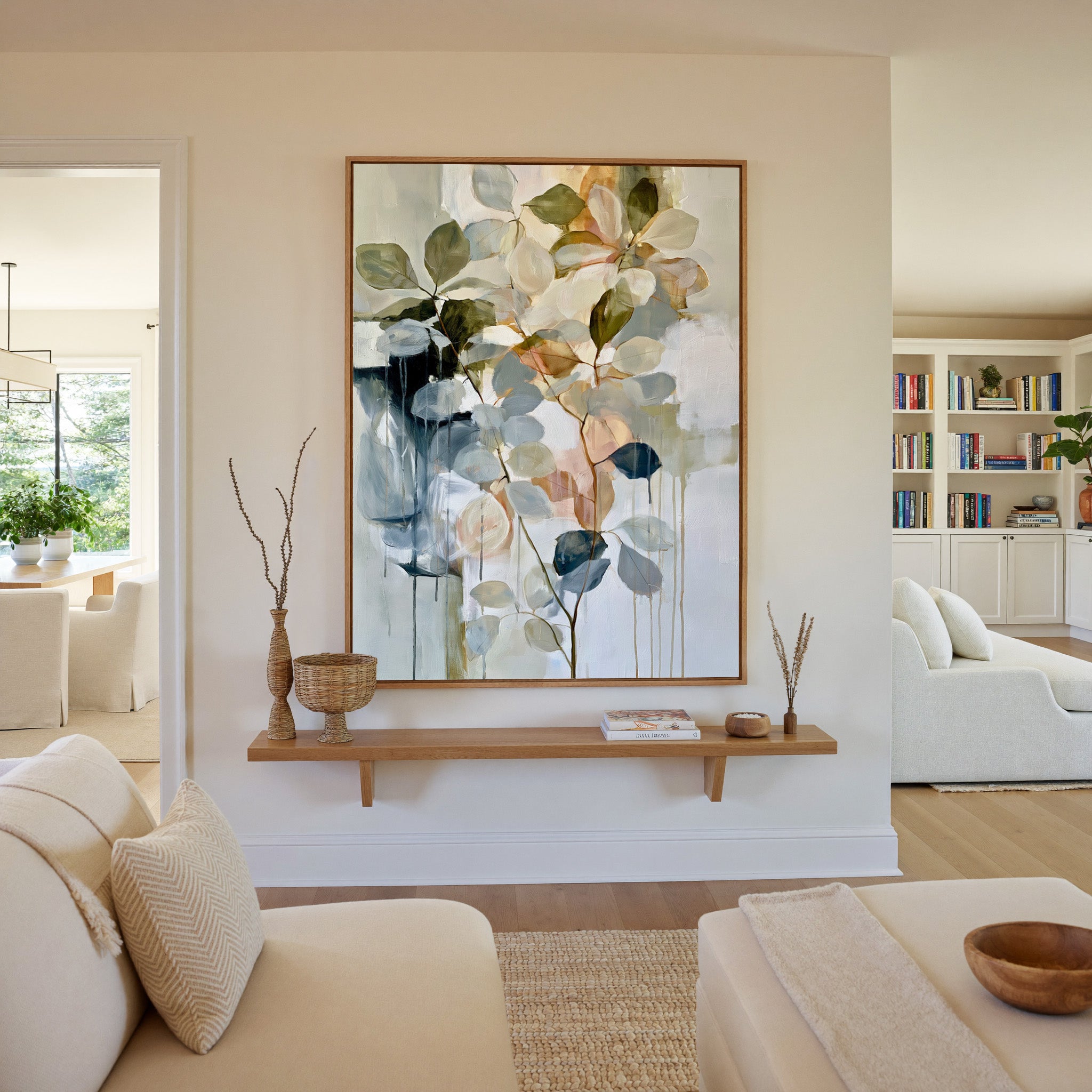 soft eucalyptus like leaves in cream, sage, canvas wall art in an oak frame in a living room