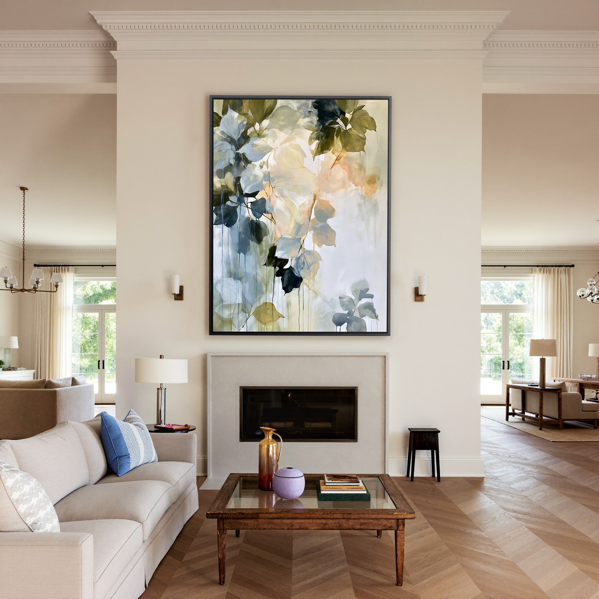 soft blue, sage, cream, and peach leaf forms canvas wall art in a black frame above a mantel
