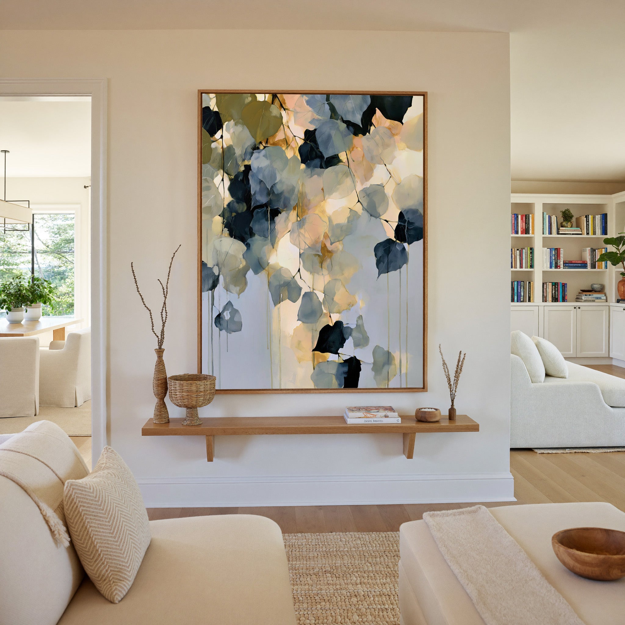 soft blue gray and gold abstract with hanging canvas wall art in an oak frame in a living room