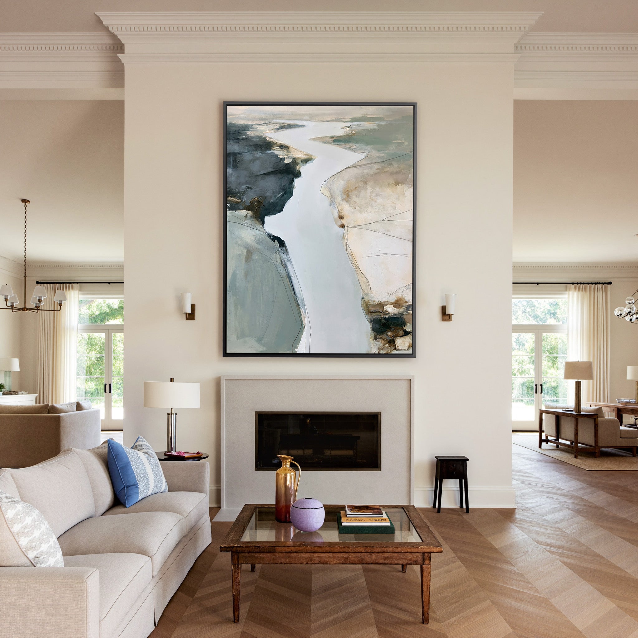 pale coastal channel abstract with slate, sand, canvas wall art in a black frame above a mantel