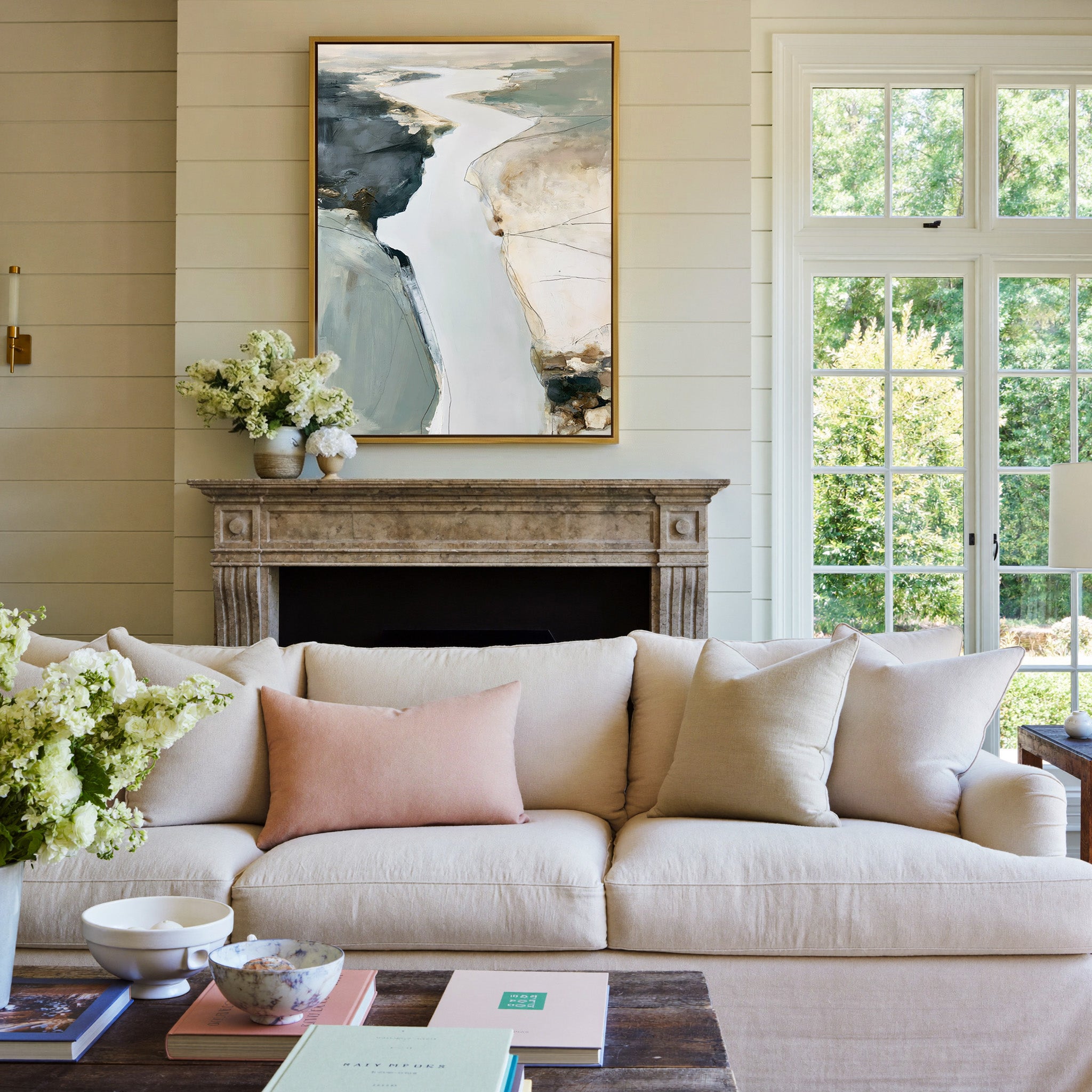 pale coastal channel abstract with slate, sand, canvas wall art in a gold frame above a mantel
