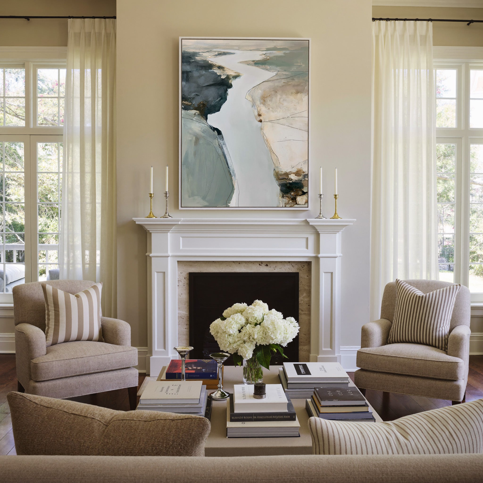 pale coastal channel abstract with slate, sand, canvas wall art in a white frame above a mantel