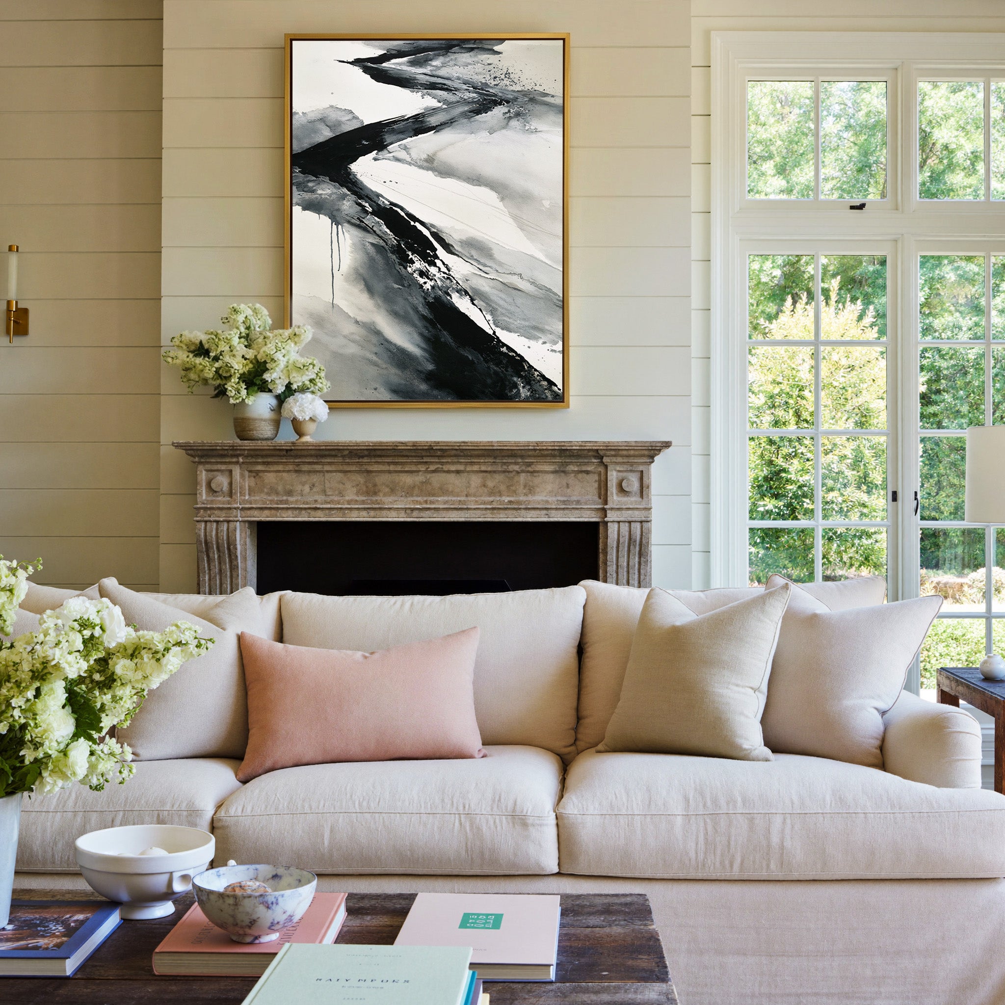 black and gray flowing abstract canvas wall art in a gold frame above a mantel