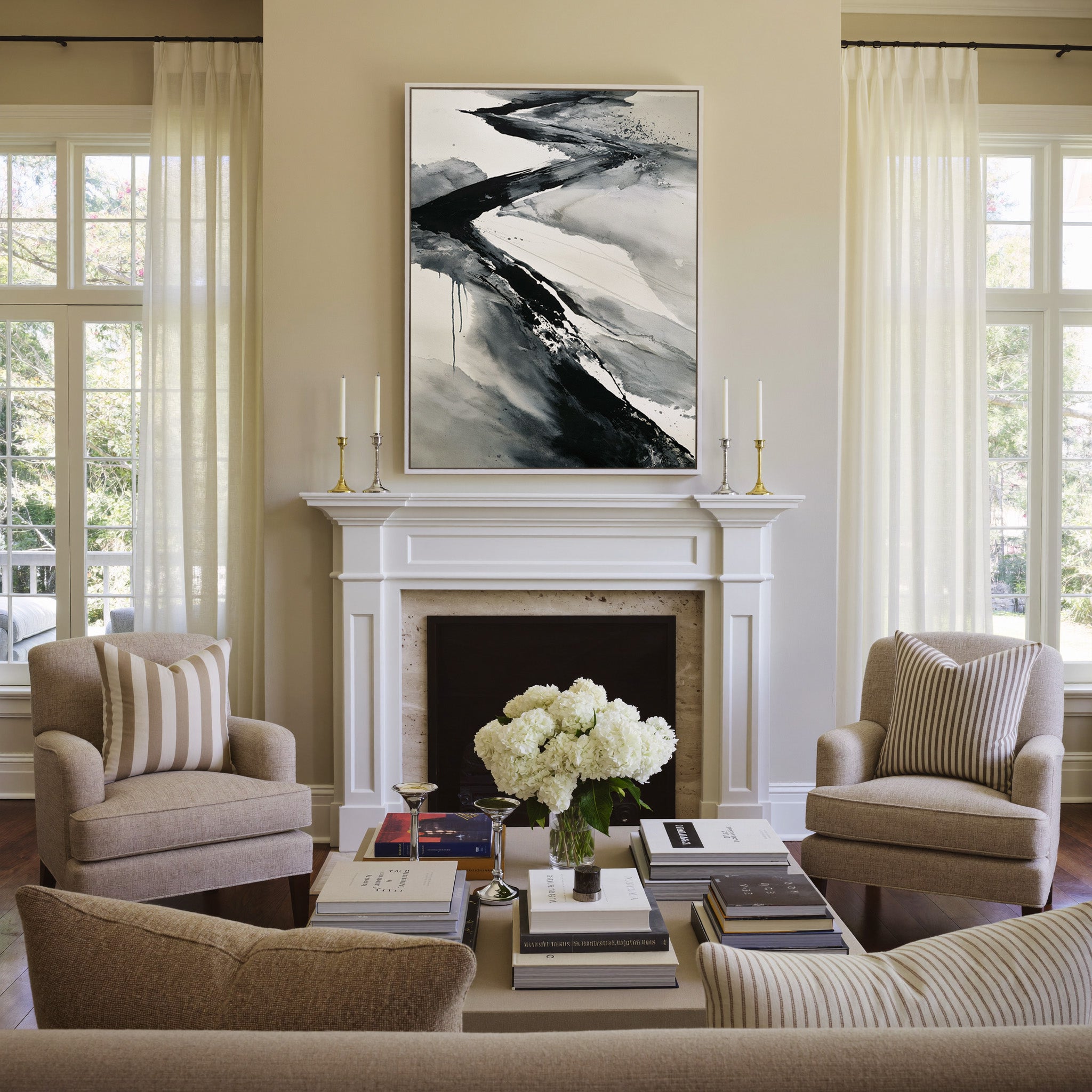 black and gray flowing abstract canvas wall art in a white frame above a mantel