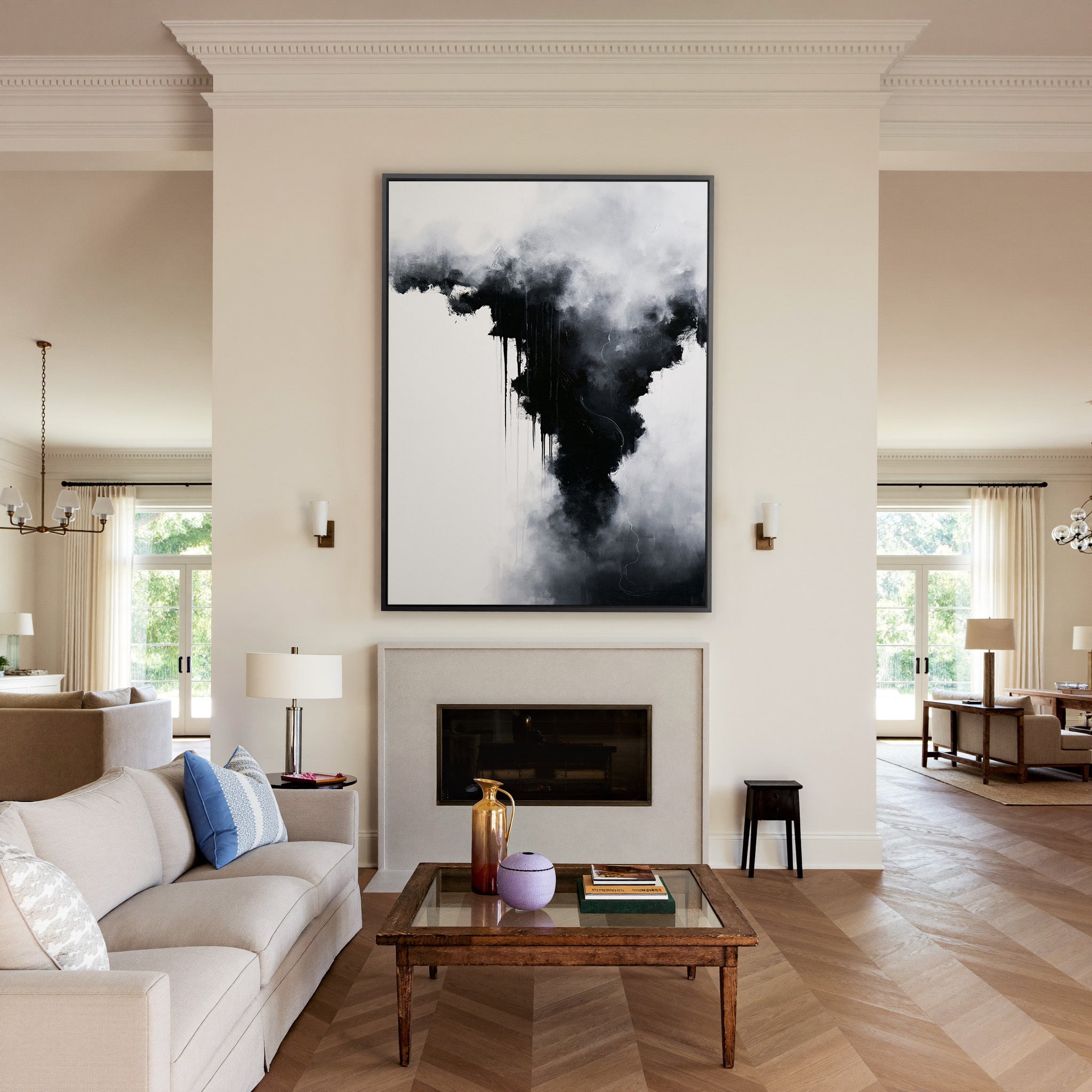 black and white abstract with smoky gray clouds canvas wall art in a black frame above a mantel