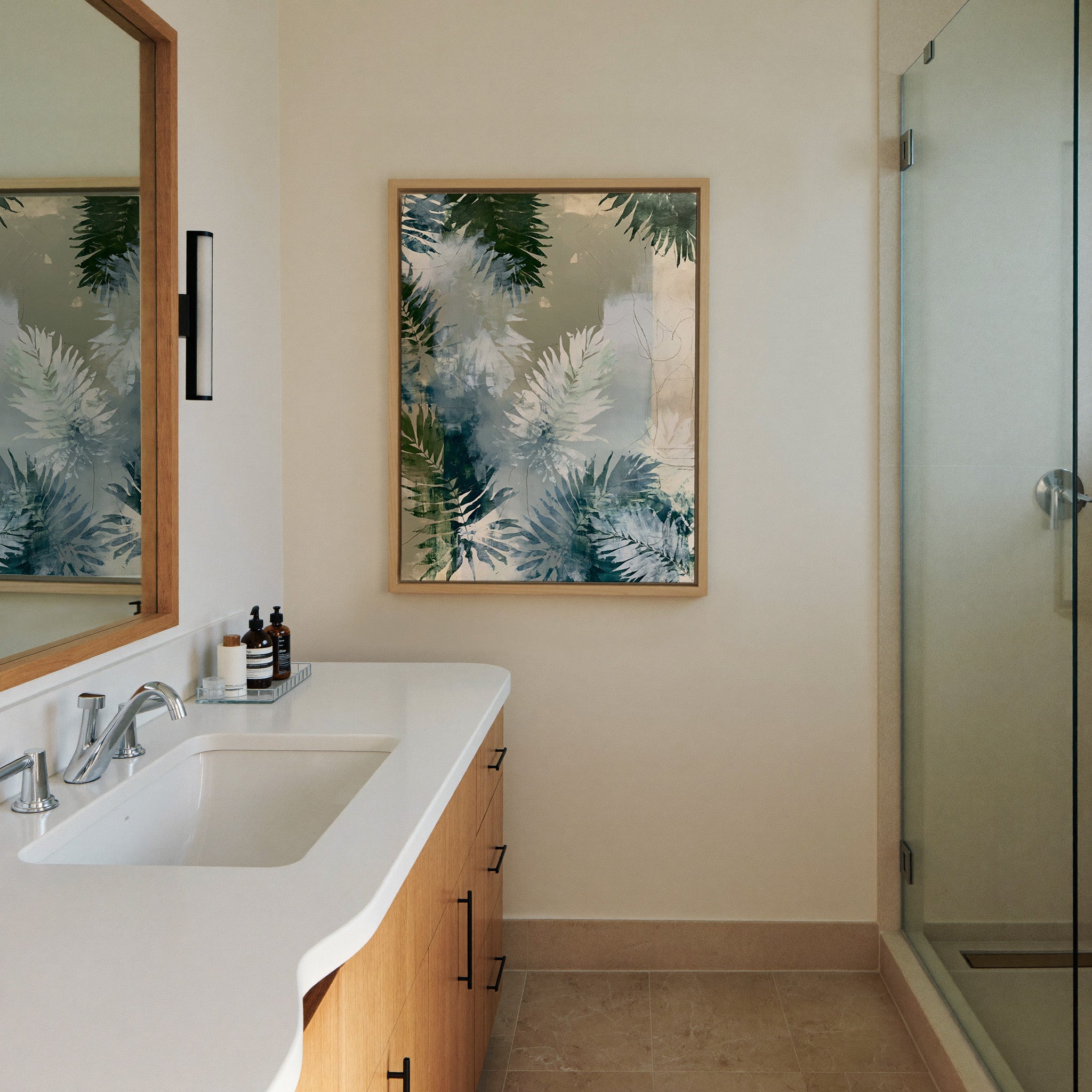 layered fern leaves in sage, blue gray, and canvas wall art in a natural wood frame in a styled room setting