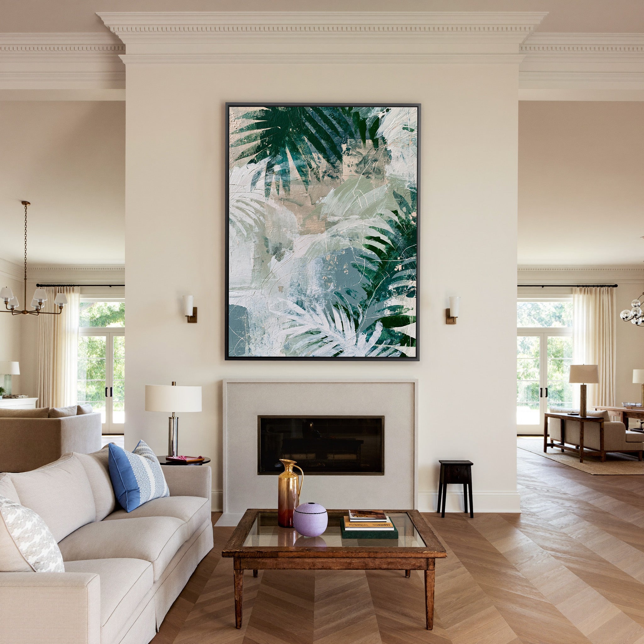 layered fern leaves in deep green, sage, white, canvas wall art in a black frame above a mantel