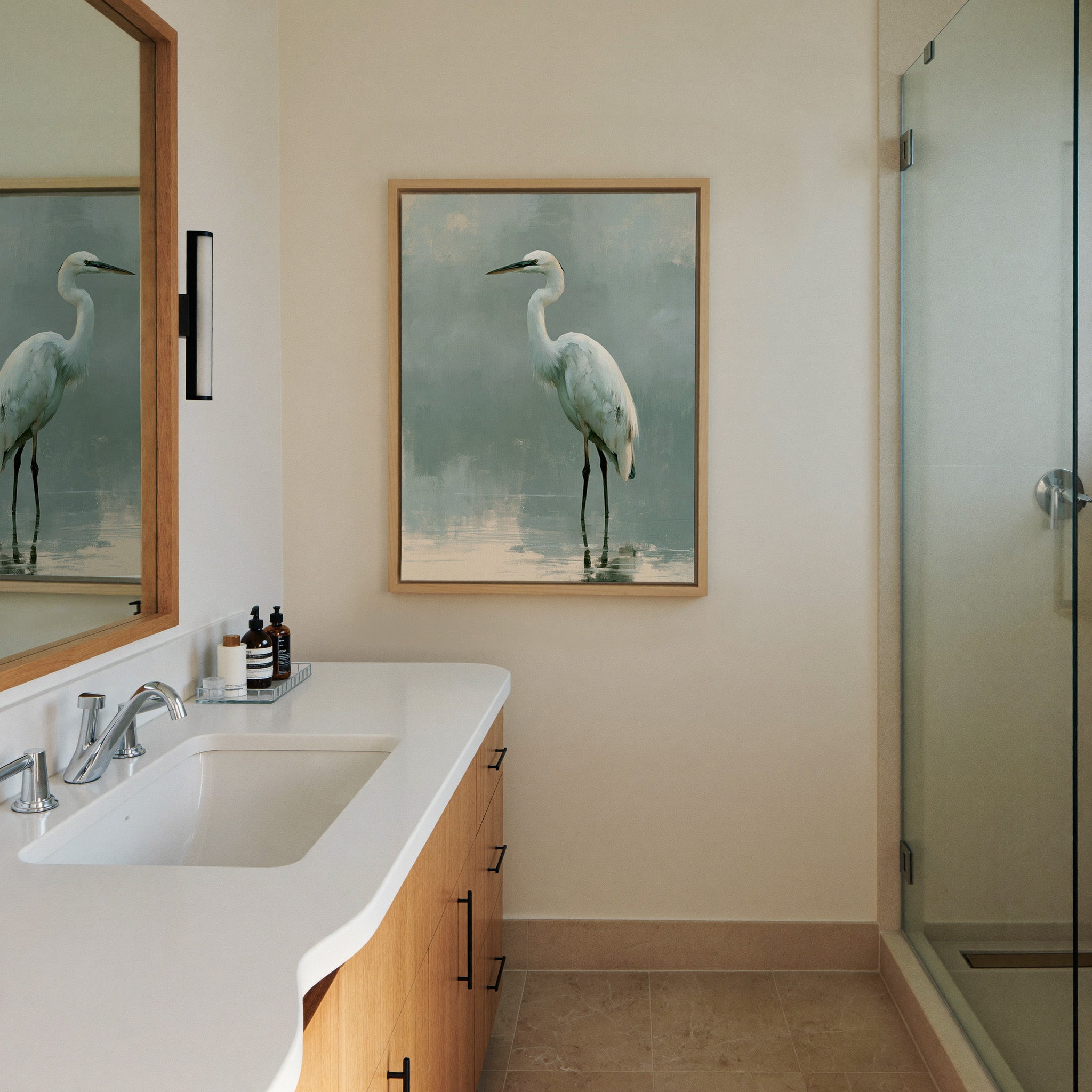white heron in pale reflective water canvas wall art in a natural wood frame in a styled room setting
