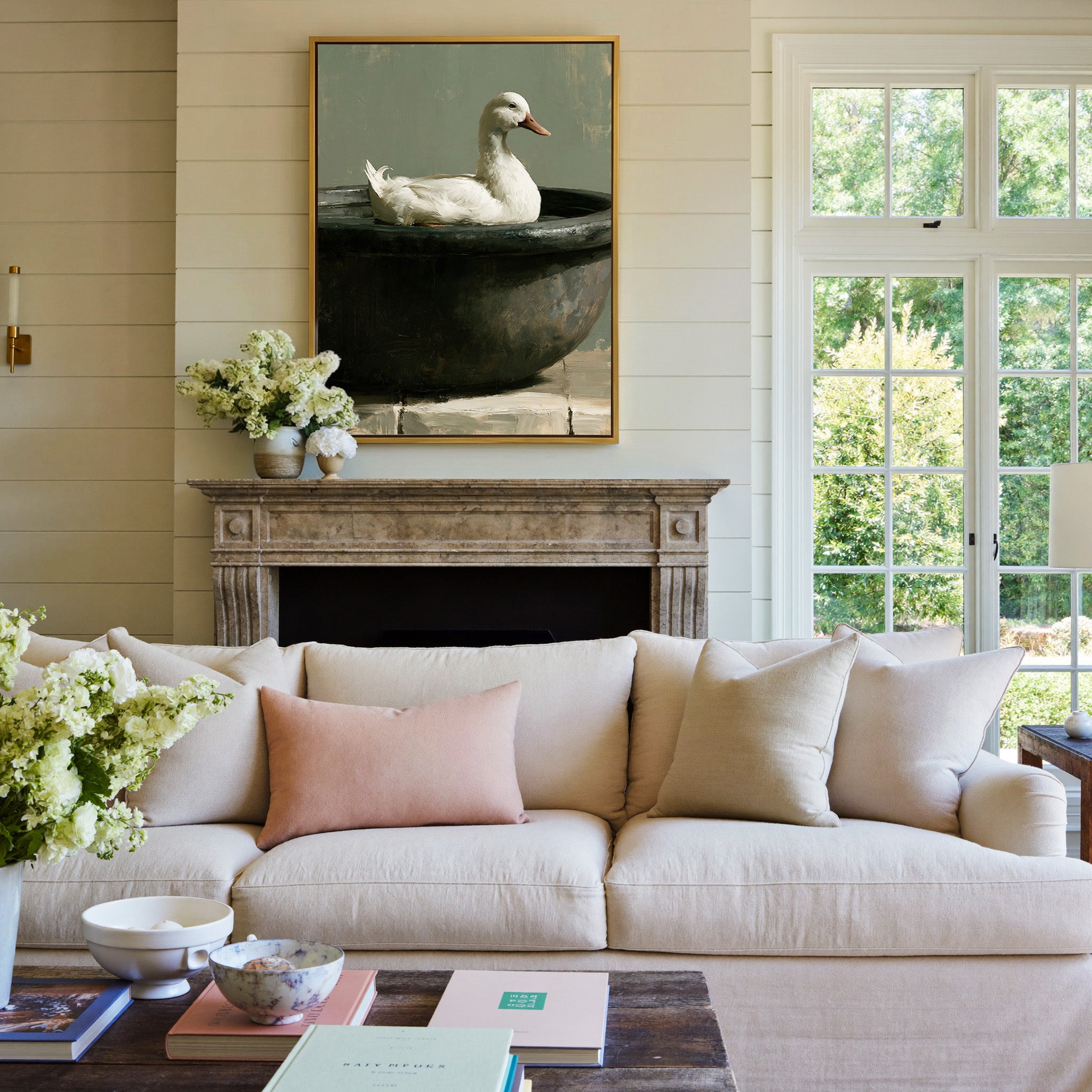 white duck in a dark round basin canvas wall art in a gold frame above a mantel