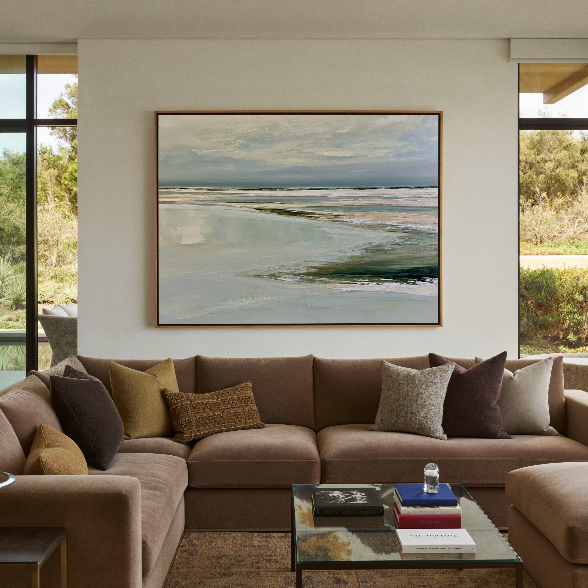 pale reflective shoreline with low horizontal canvas wall art in an oak frame in a styled room setting