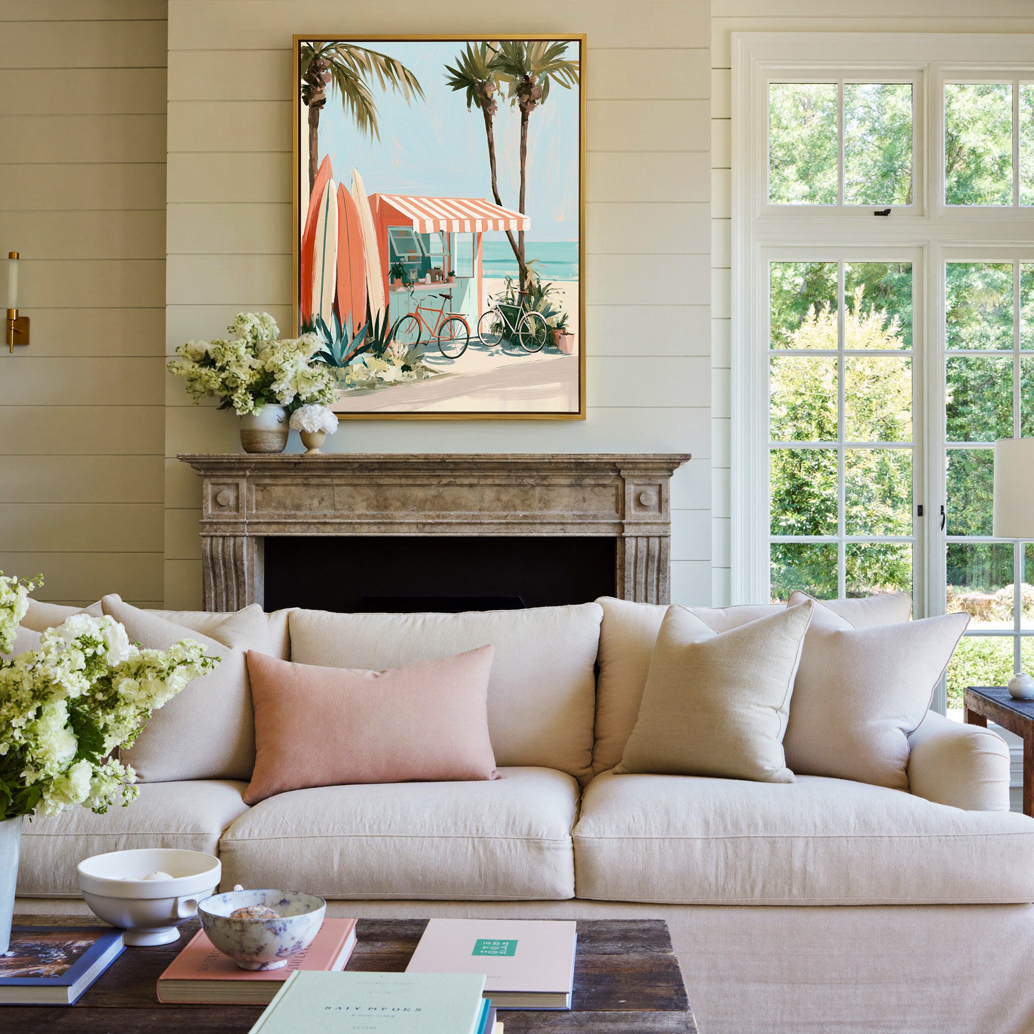coral kiosk with striped awning and surfboards canvas wall art in a gold frame above a mantel