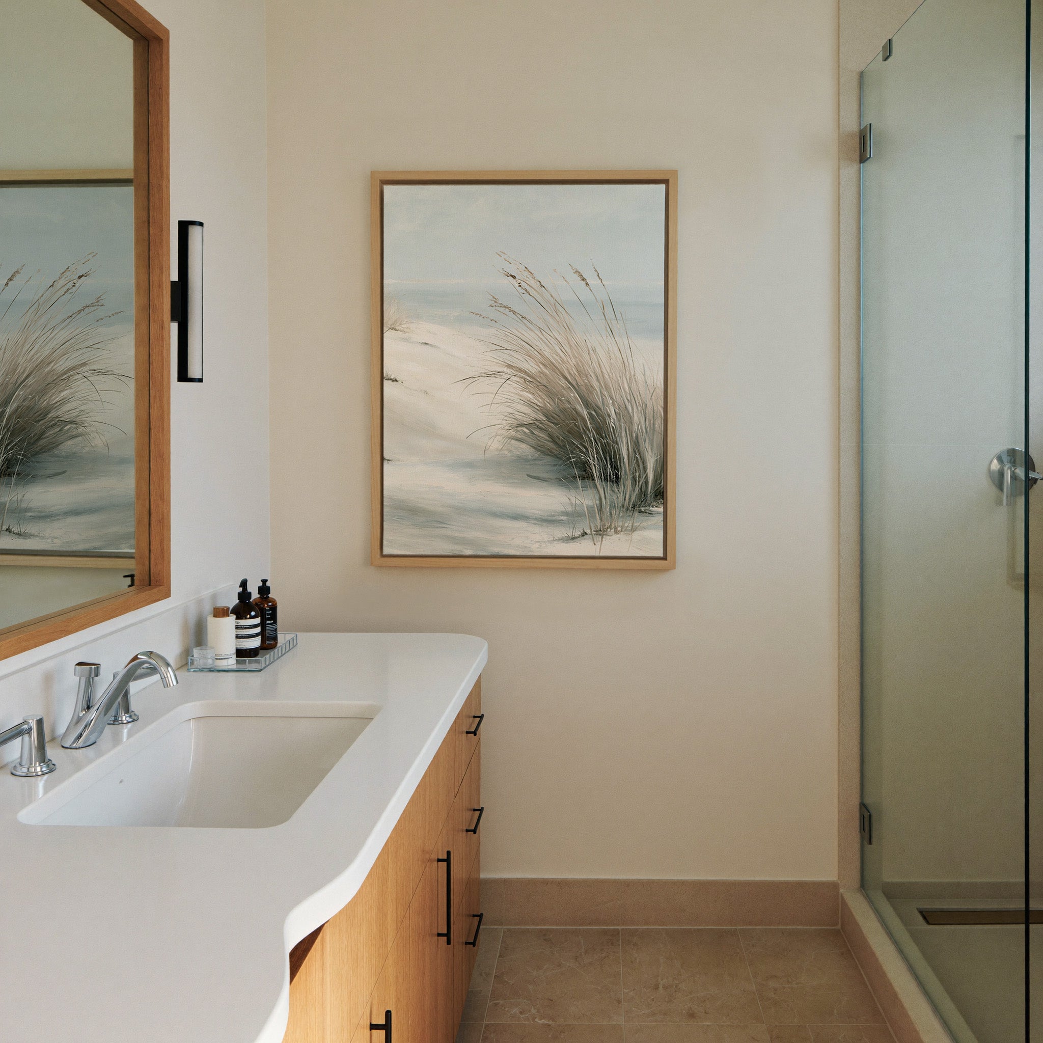pale dune grass over soft blue water canvas wall art in a natural wood frame in a styled room setting