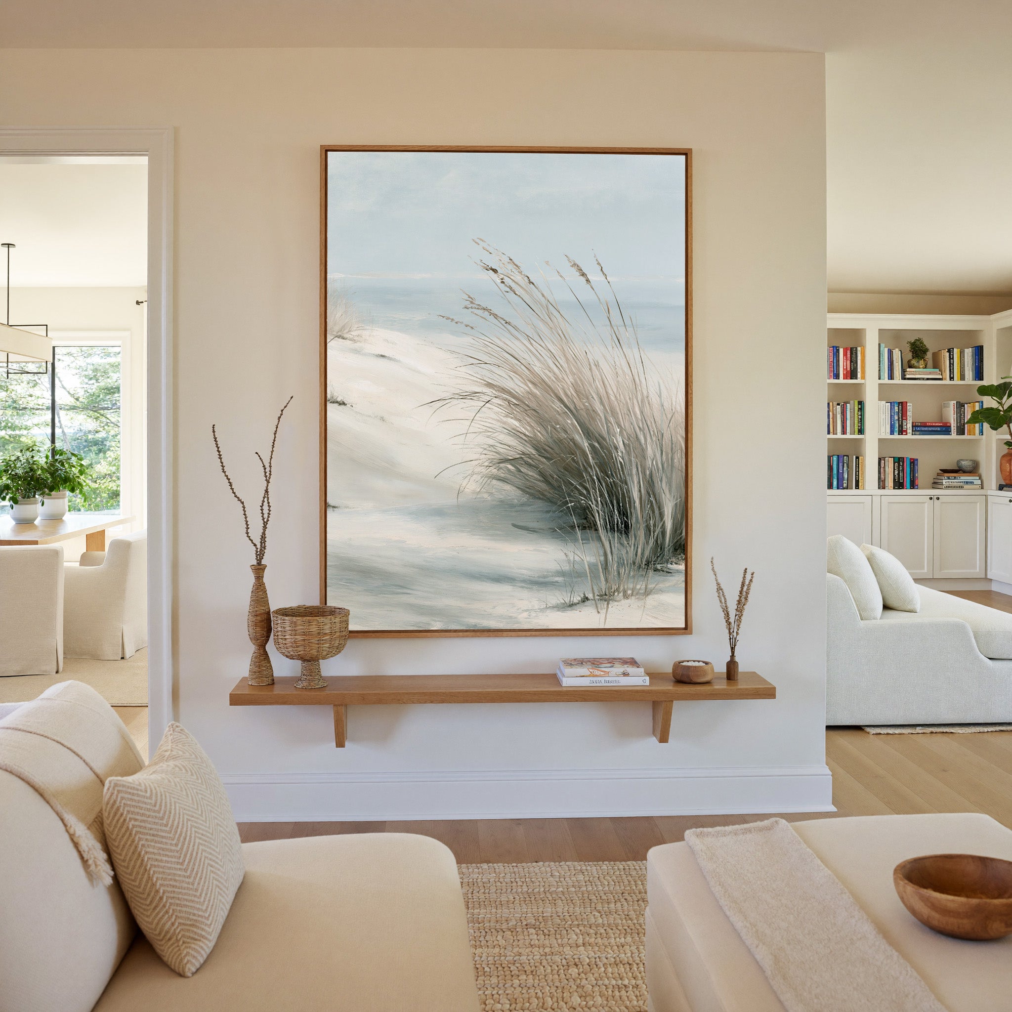 pale dune grass over soft blue water canvas wall art in an oak frame in a living room