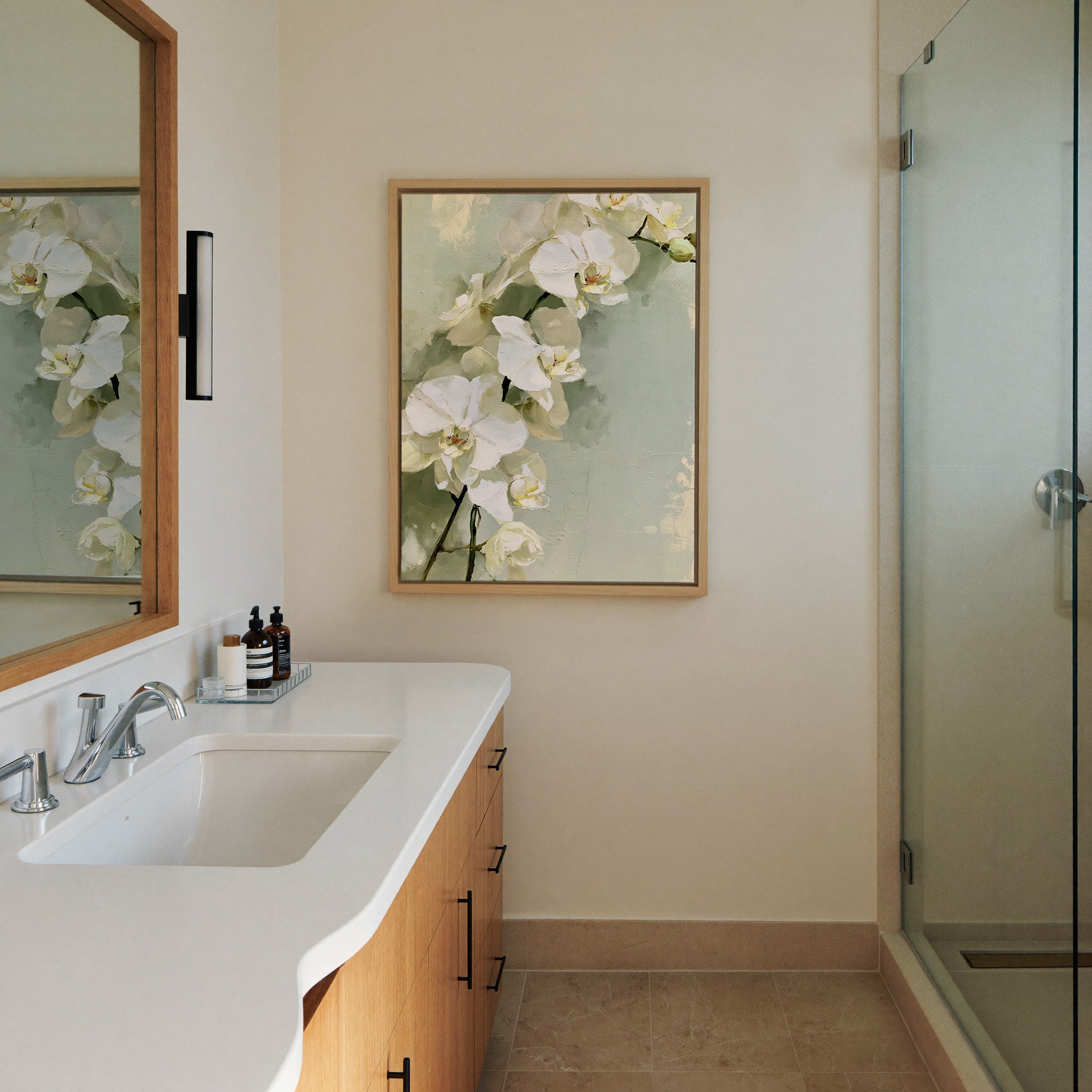 white orchids with long stems on a pale green canvas wall art in a natural wood frame in a styled room setting