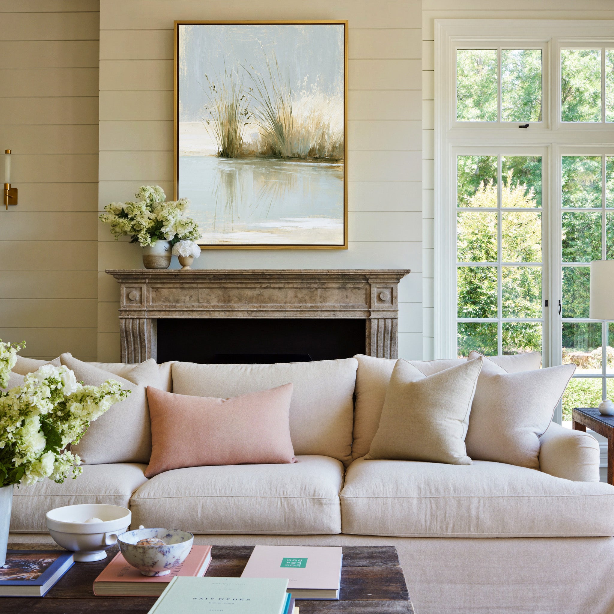 pale reeds and grasses by still water canvas wall art in a gold frame above a mantel