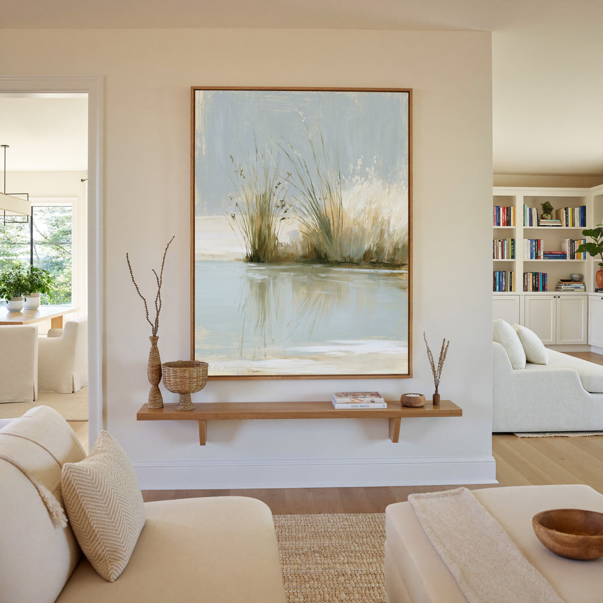 pale reeds and grasses by still water canvas wall art in an oak frame in a living room
