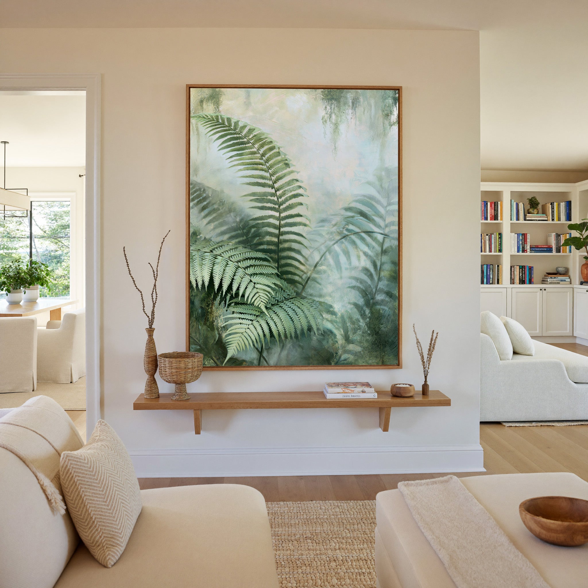 layered green fern fronds in a misty pale canvas wall art in an oak frame in a living room