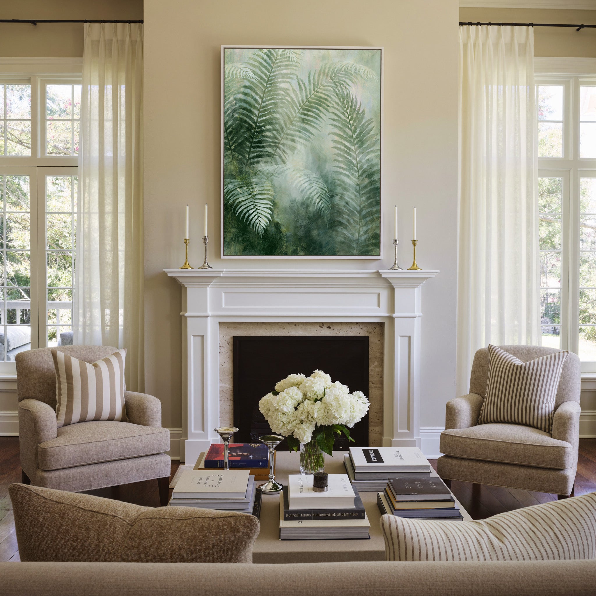soft green fern fronds over a misty pale ground canvas wall art in a white frame above a mantel
