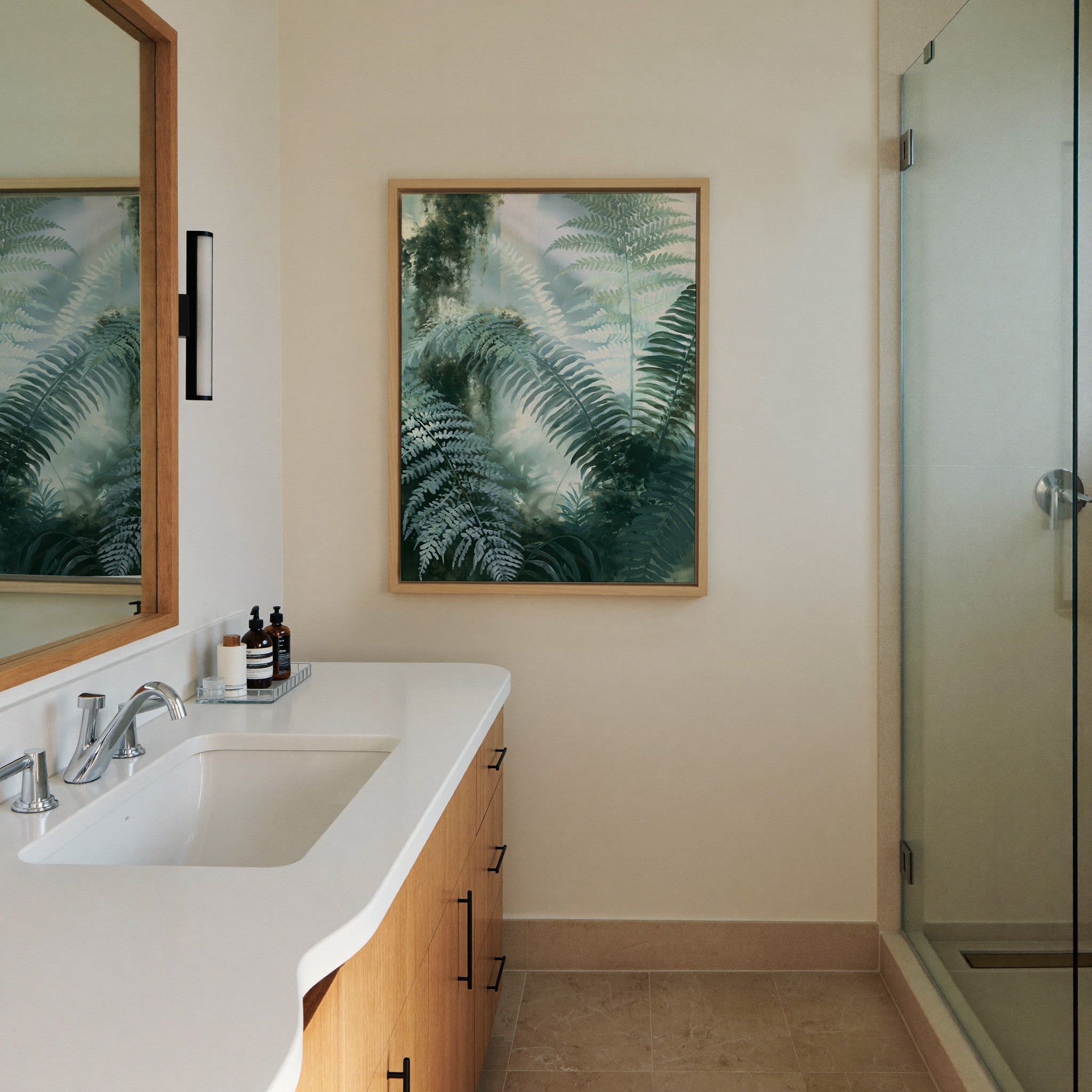 soft green fern fronds over a canvas wall art in a natural wood frame in a styled room setting