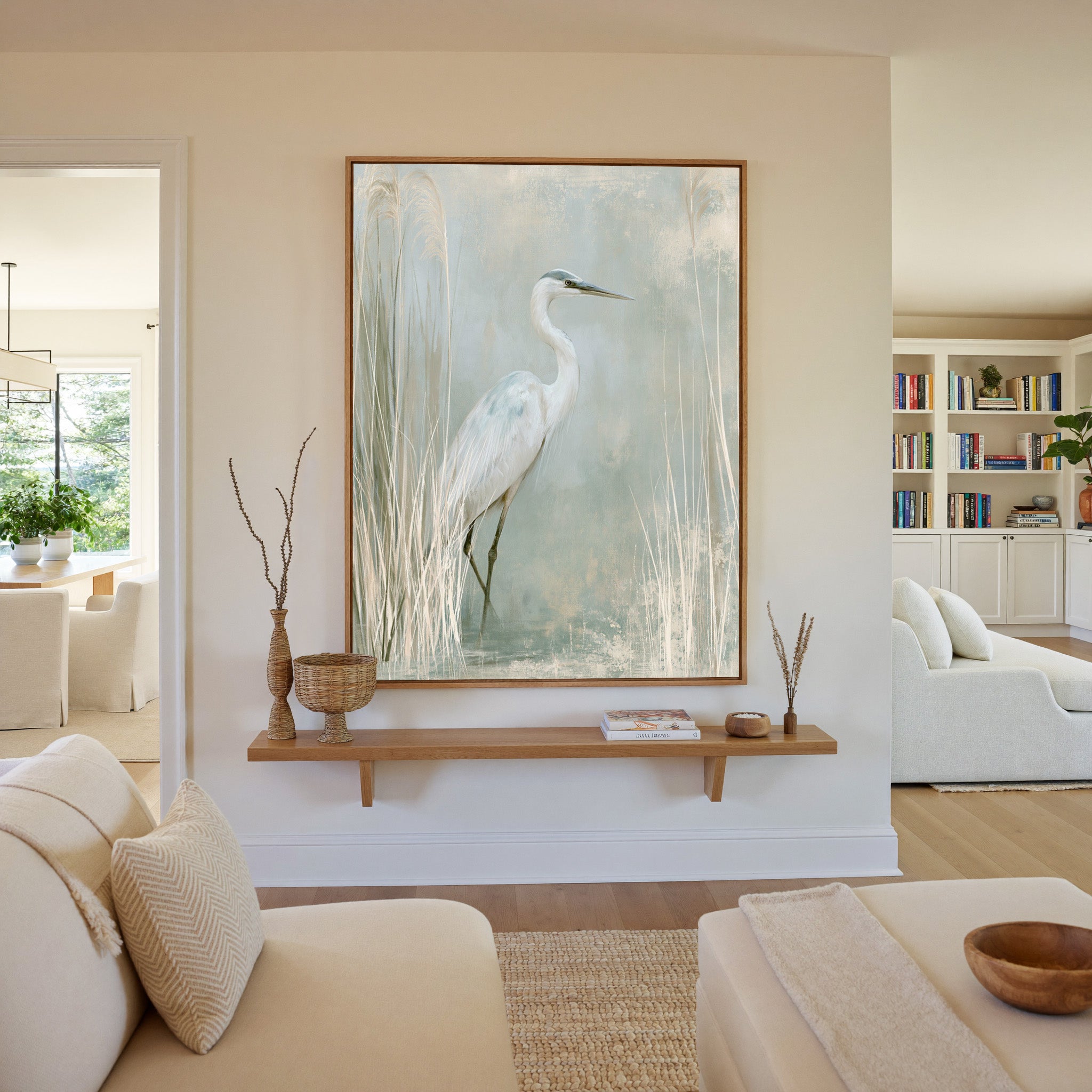 white heron among pale marsh reeds canvas wall art in an oak frame in a living room