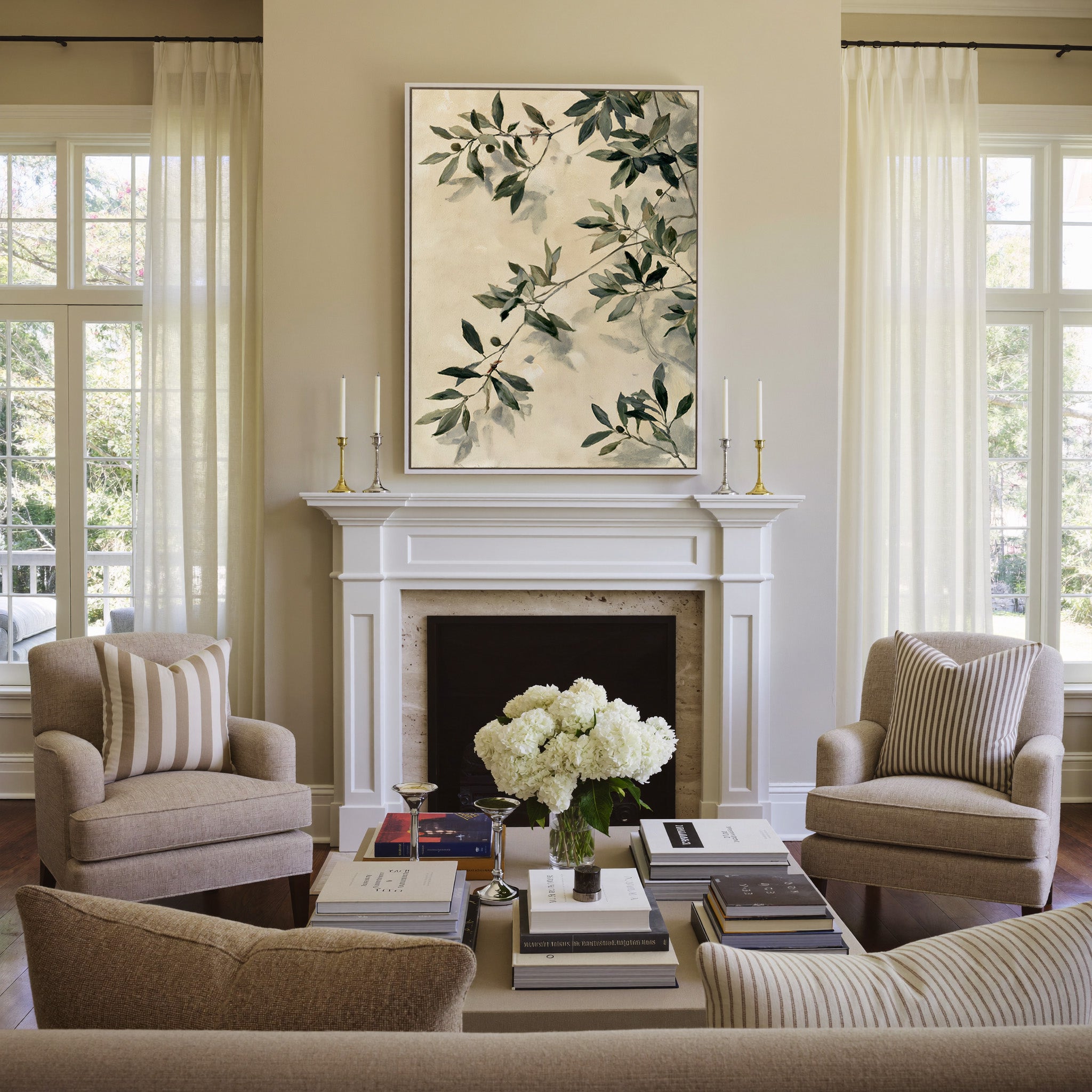 olive branches with soft sage and deep green canvas wall art in a white frame above a mantel