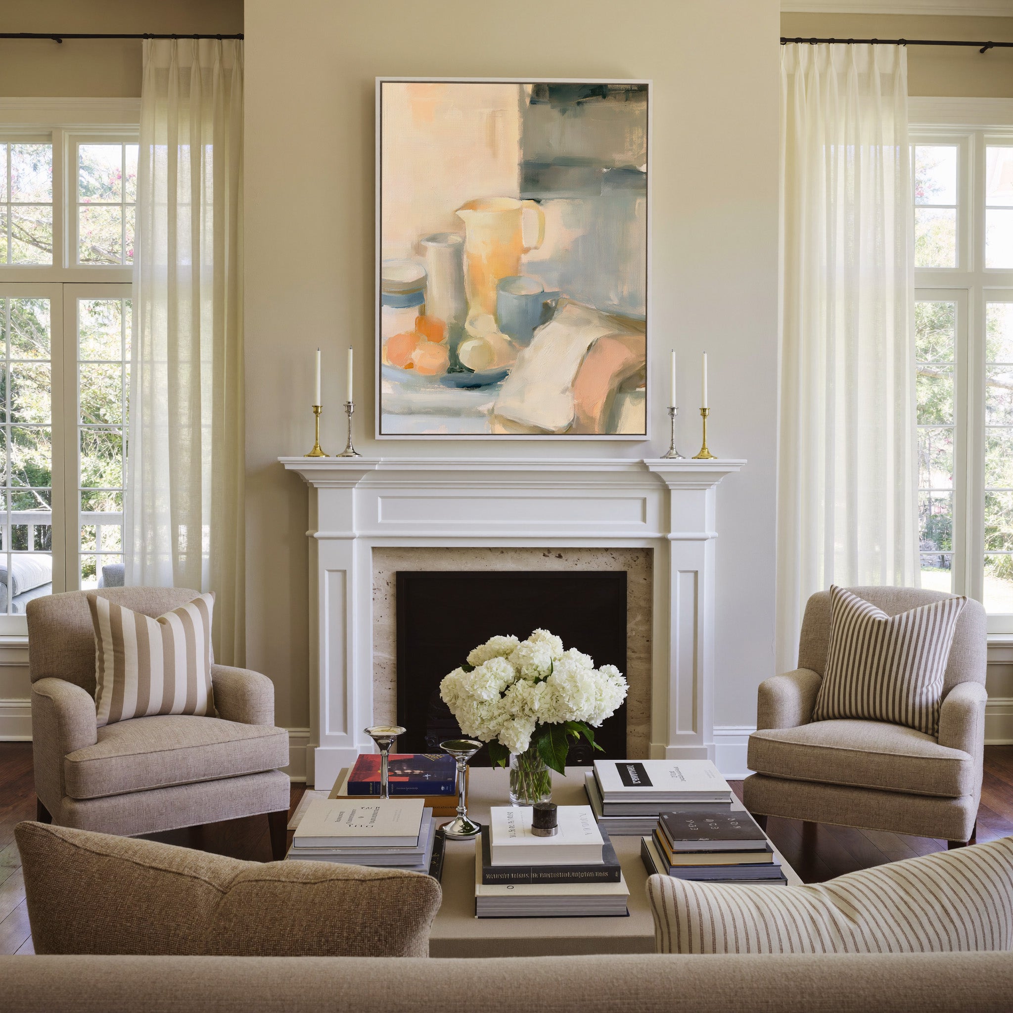 soft neutral still life with pitcher, cups, and canvas wall art in a white frame above a mantel