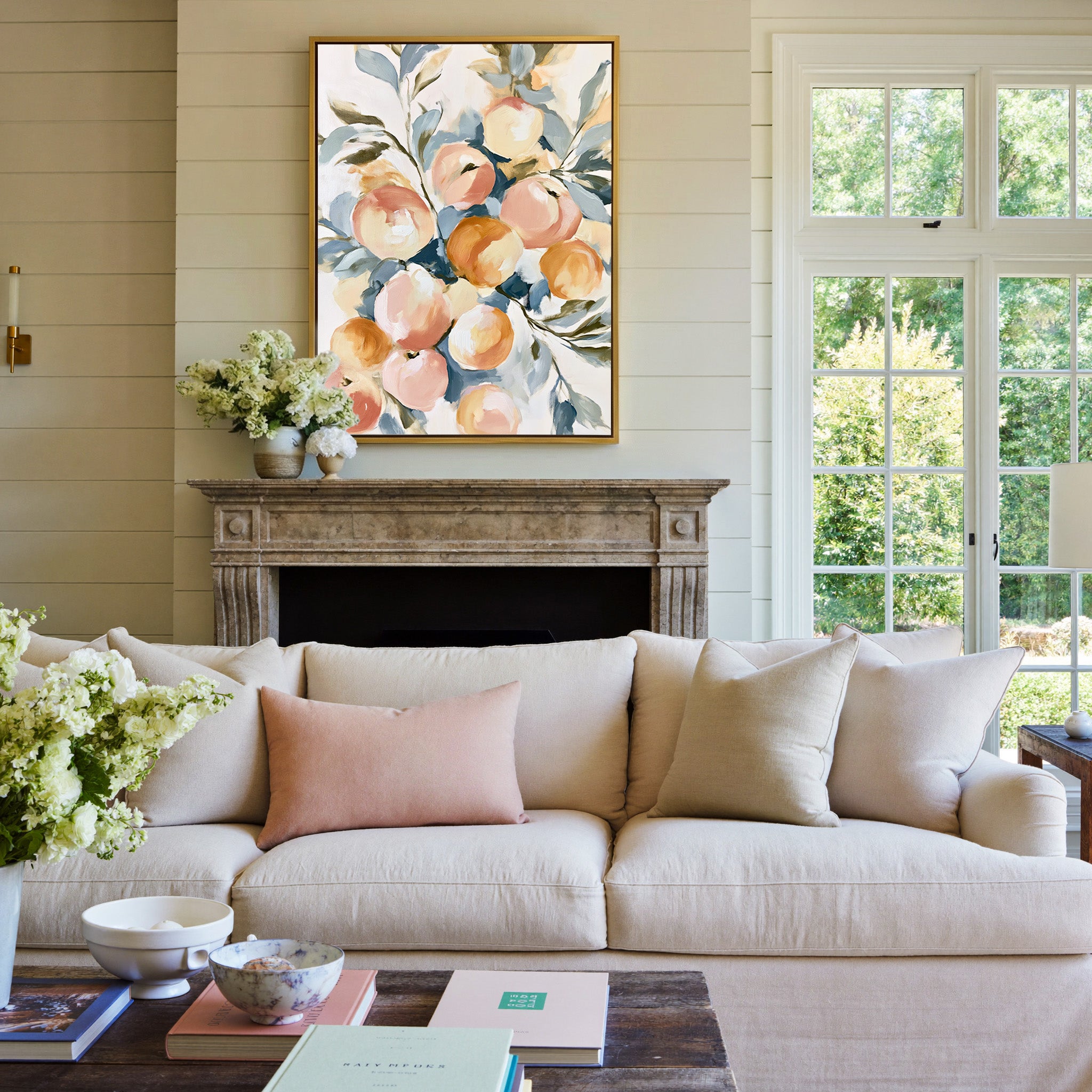 soft peaches and apricots with blue green leaves canvas wall art in a gold frame above a mantel