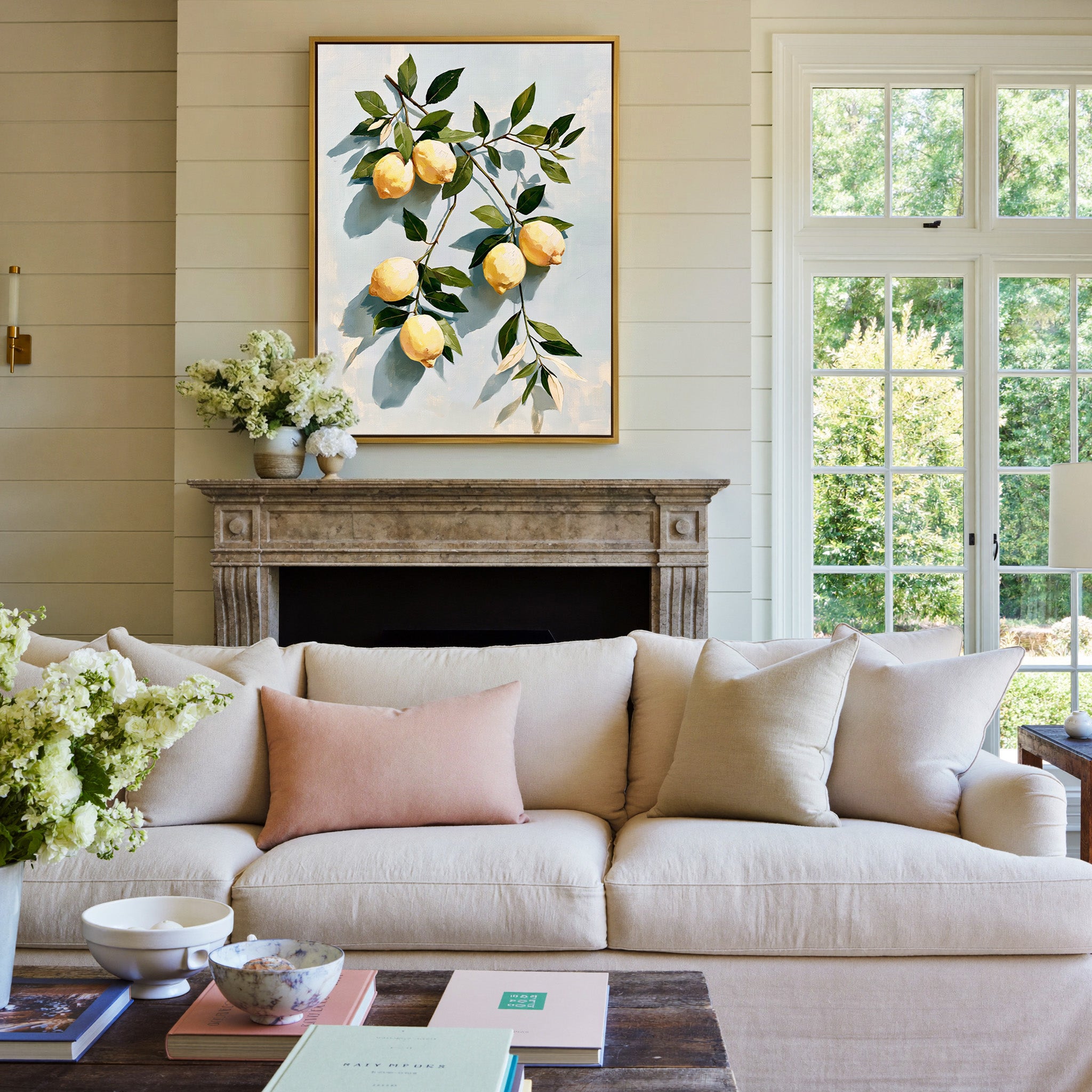 muted lemons with olive leaves on a pale blue canvas wall art in a gold frame above a mantel