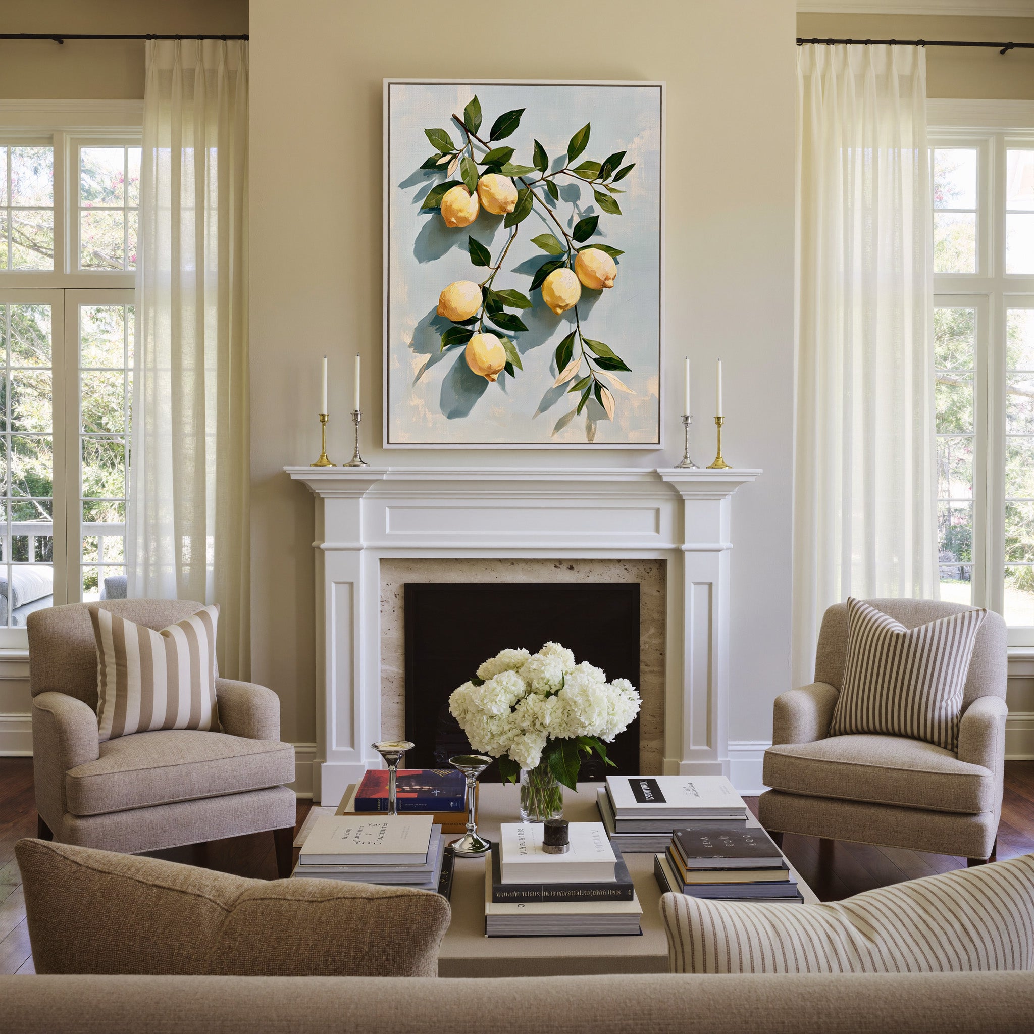 muted lemons with olive leaves on a pale blue canvas wall art in a white frame above a mantel