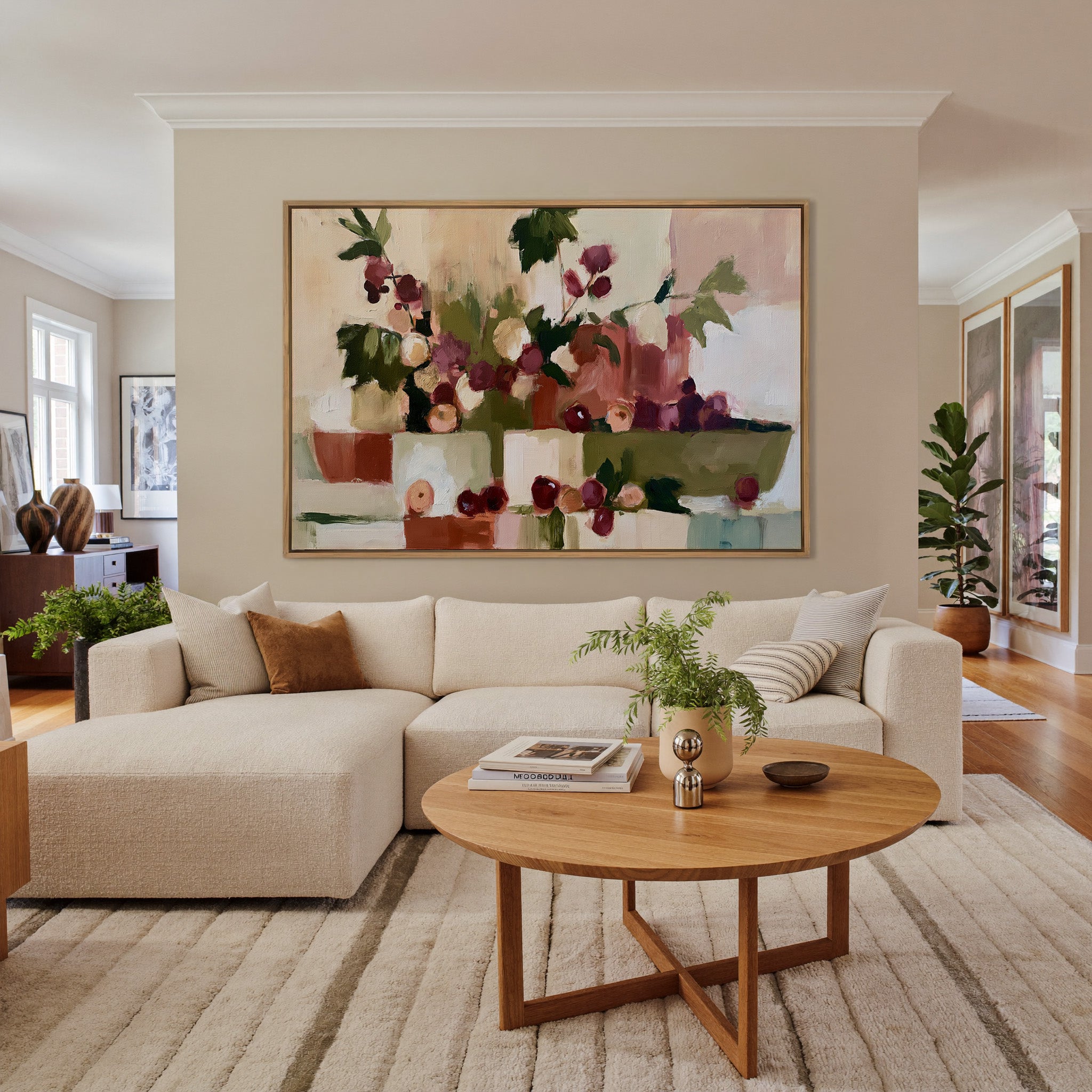warm abstract still life with grapes and leafy canvas wall art in an oak frame in a living room