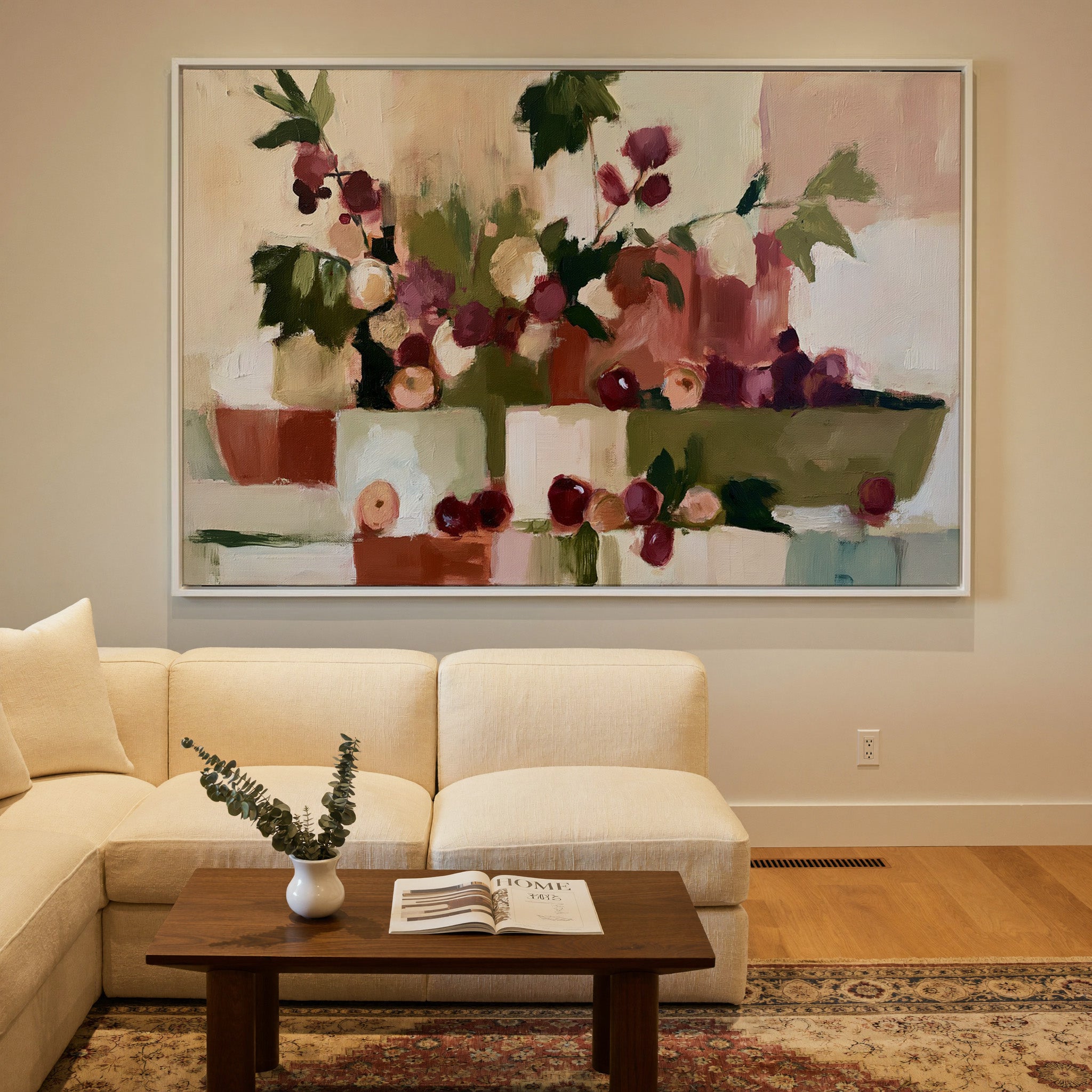 warm abstract still life with grapes and leafy canvas wall art in a white frame in a styled room setting