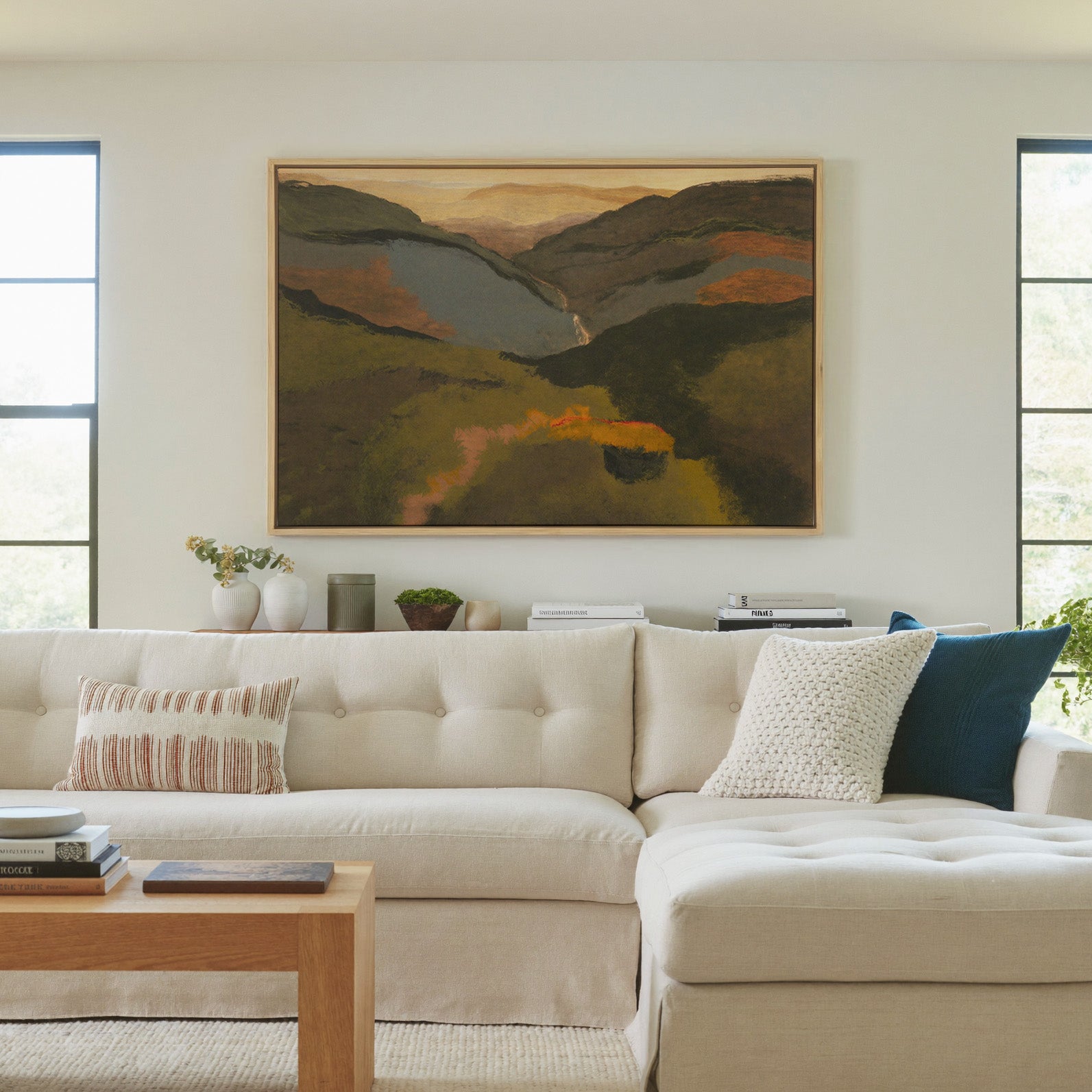 layered mountain valley at dusk canvas wall art in a natural wood frame in a living room