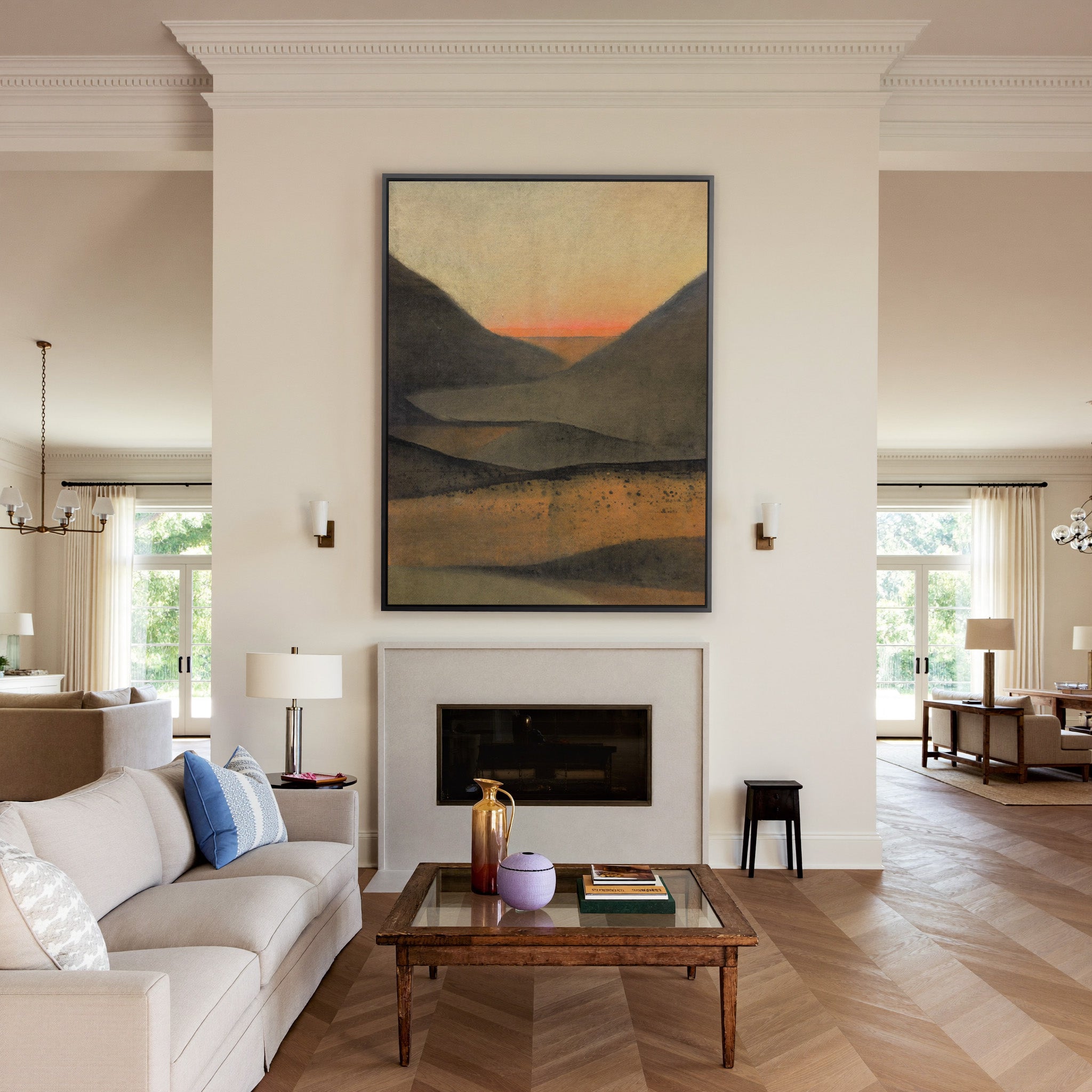 dark mountain landscape with a narrow orange canvas wall art in a black frame above a mantel