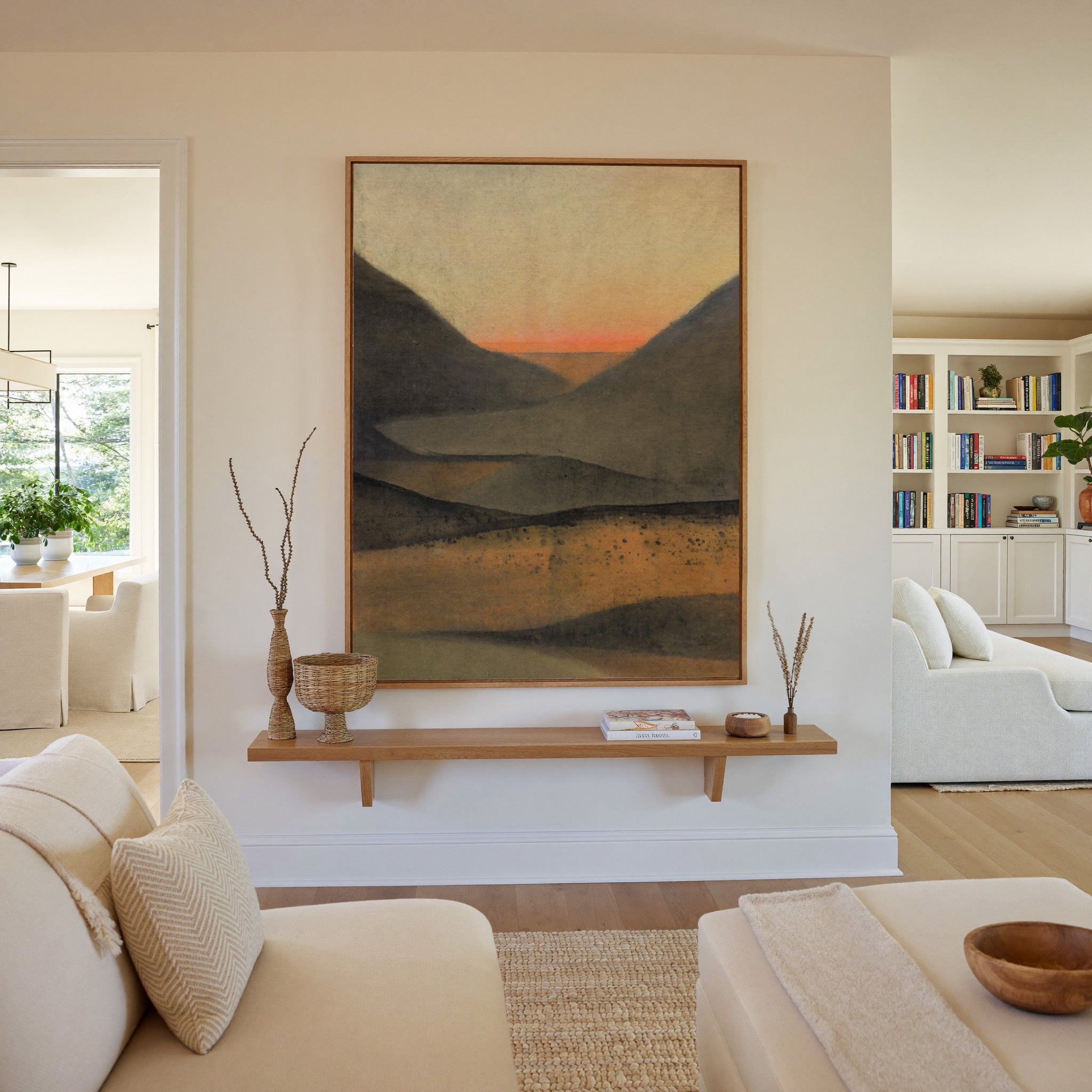 dark mountain landscape with a narrow orange canvas wall art in an oak frame in a living room