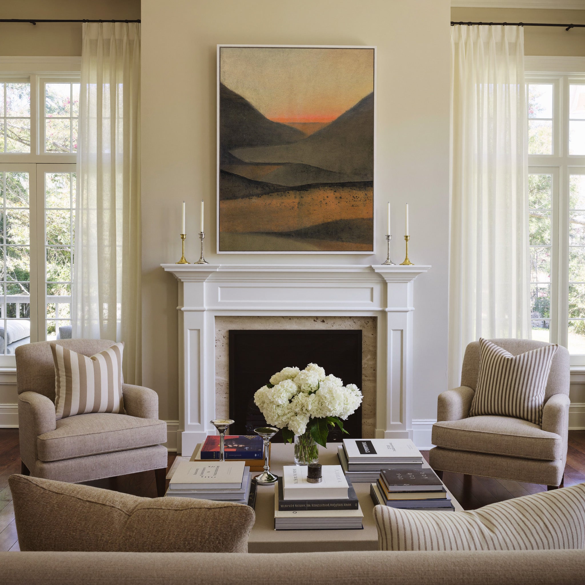 dark mountain landscape with a narrow orange canvas wall art in a white frame above a mantel