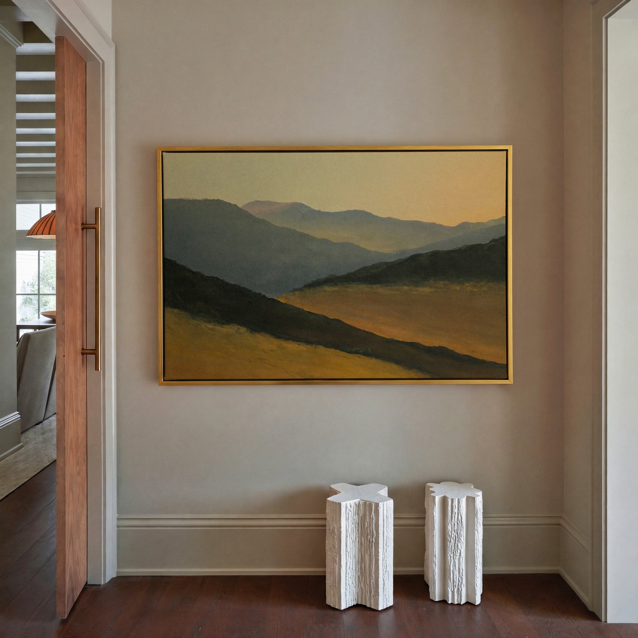 layered mountain ridges at sunset canvas wall art in a gold frame in a styled room setting