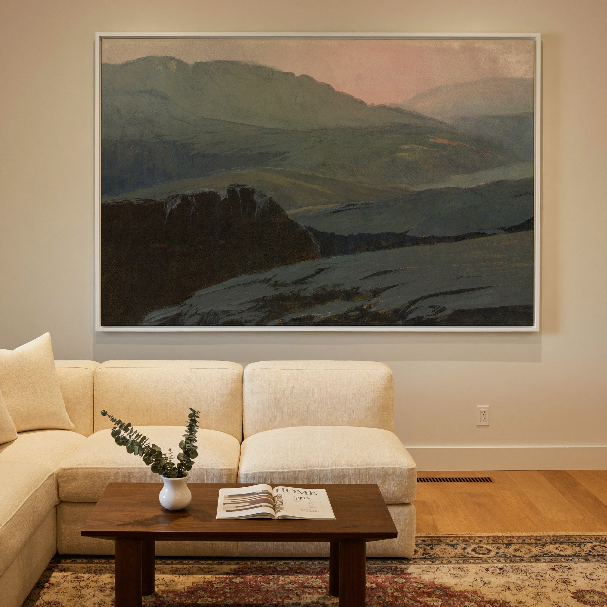 misty mountain landscape with dark foreground canvas wall art in a white frame in a styled room setting