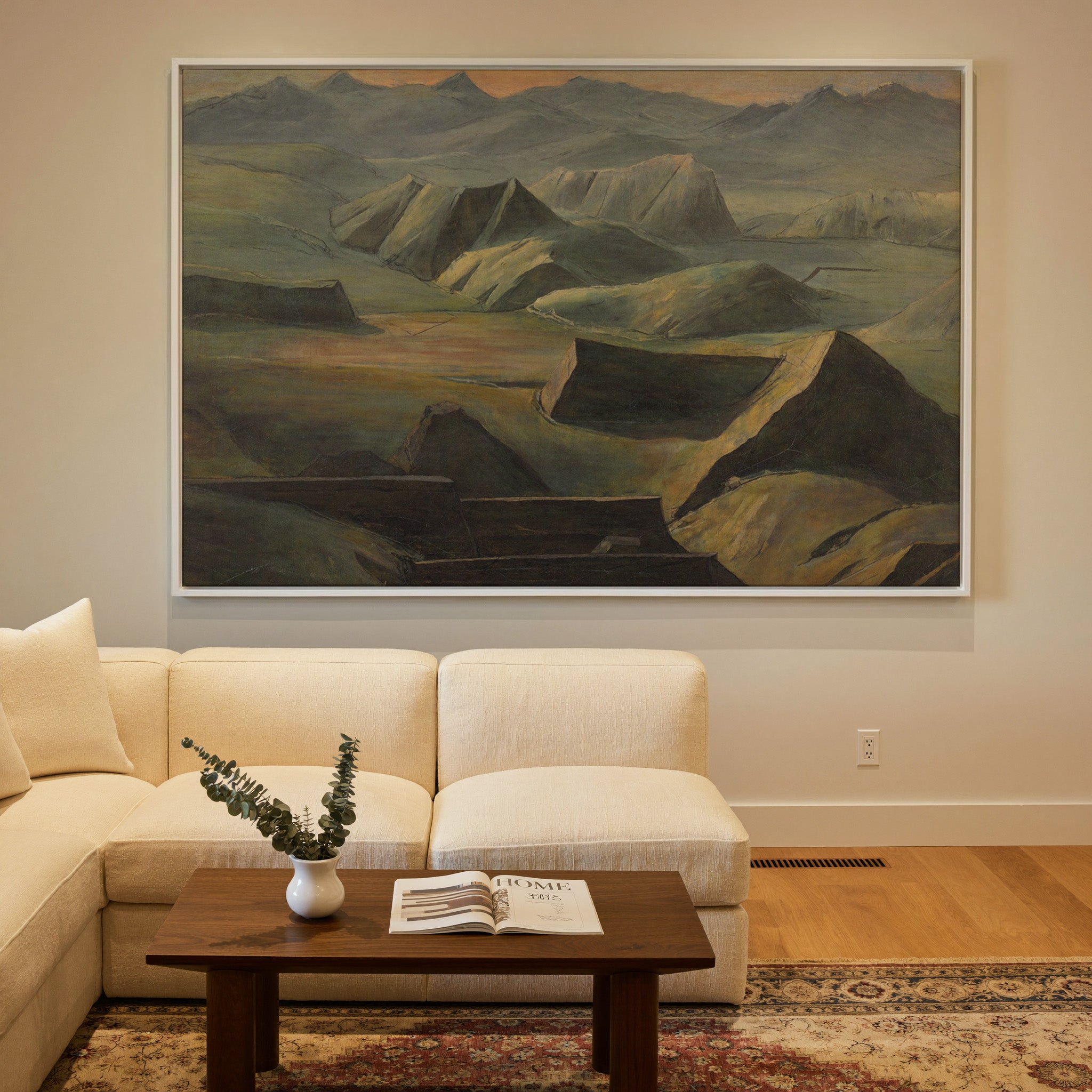 layered mountain ridges with copper light canvas wall art in a white frame in a styled room setting