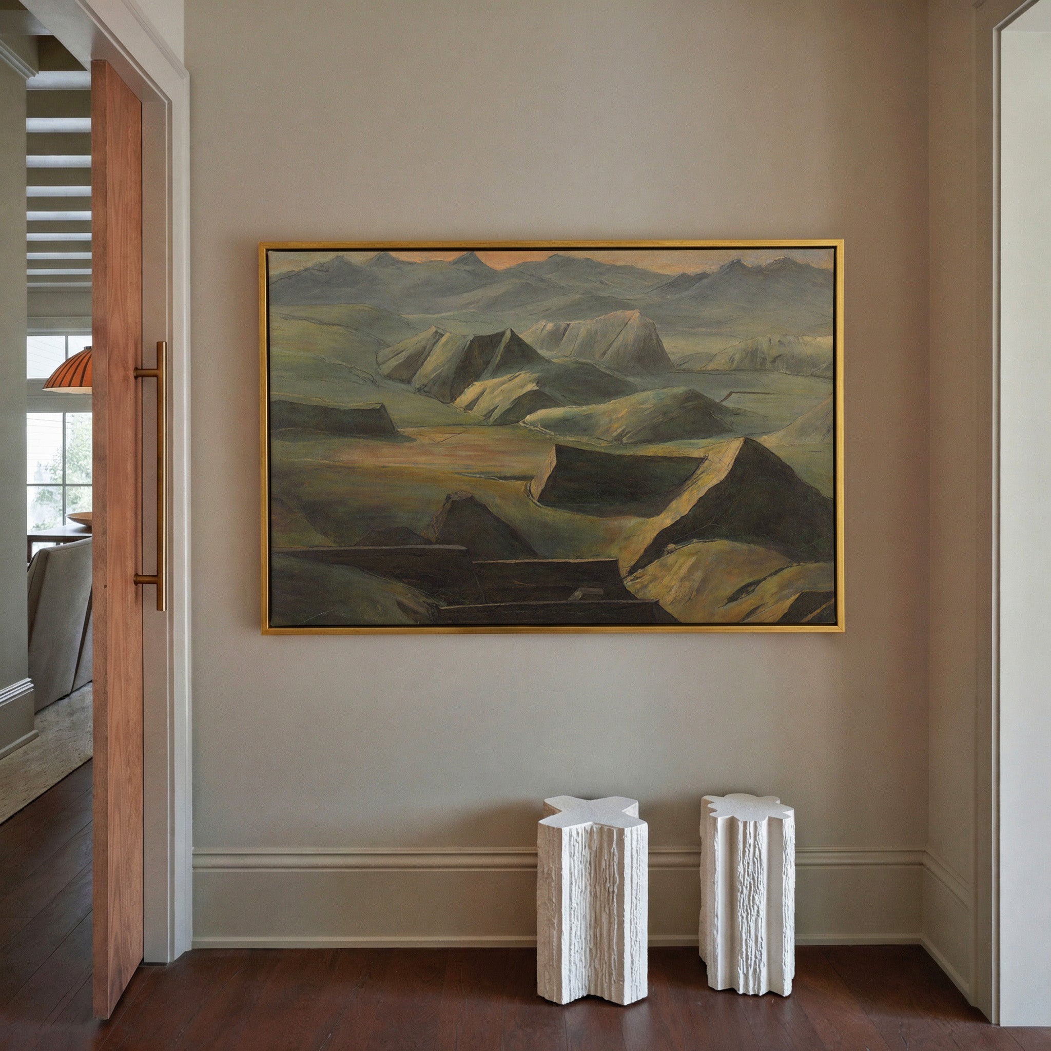 layered mountain ridges with copper light canvas wall art in a gold frame in a styled room setting