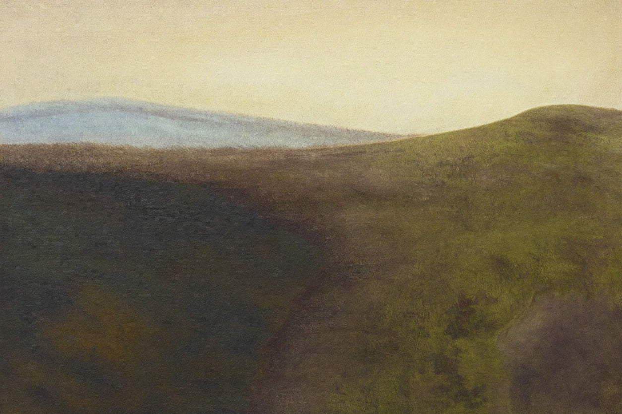 Muted green hills with a dark hollow, pale blue ridge, and cream sky across a wide horizon
