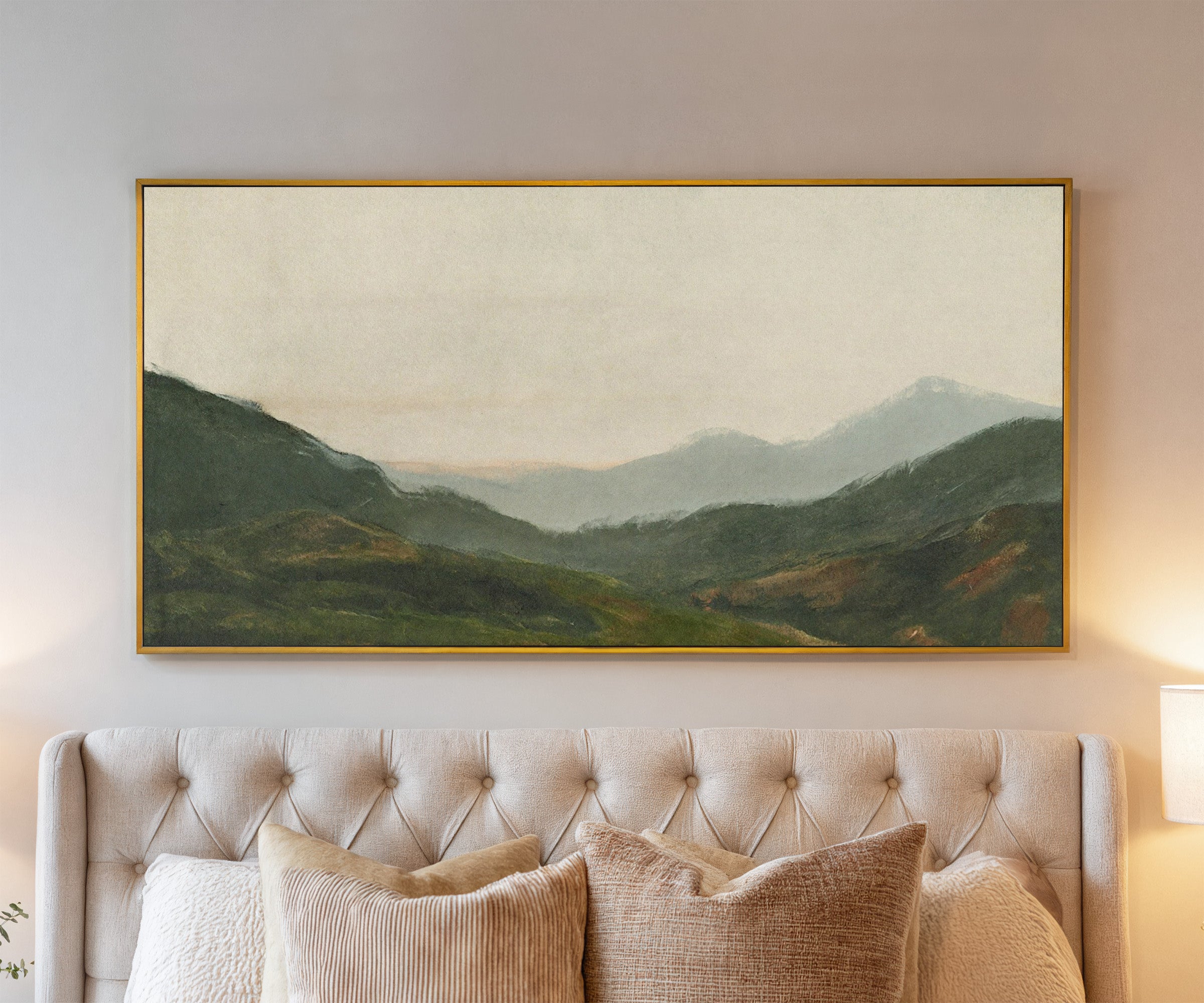 misty green mountain landscape canvas wall art in a gold frame above a bed