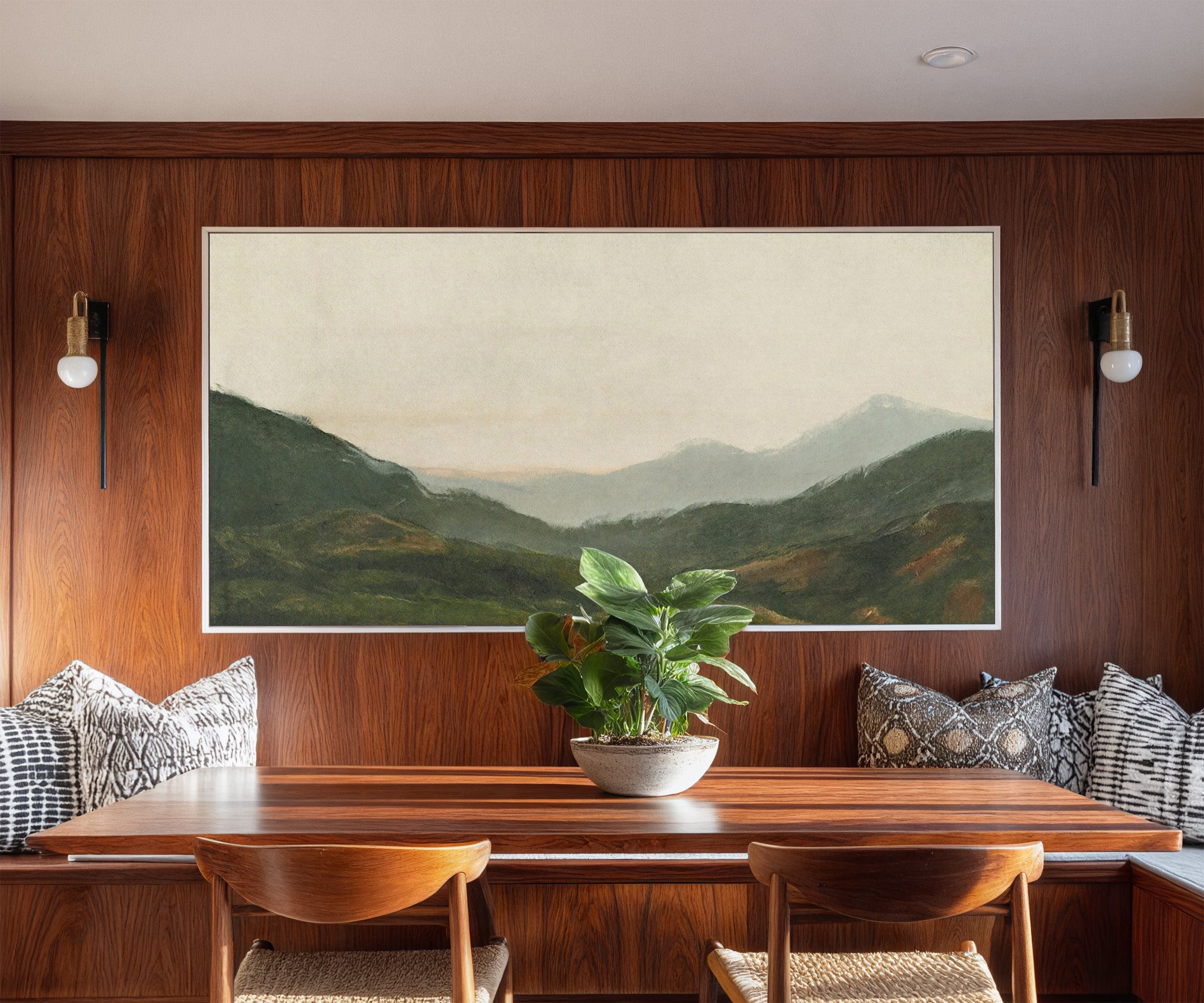 misty green mountain landscape canvas wall art in a white frame in a styled room setting