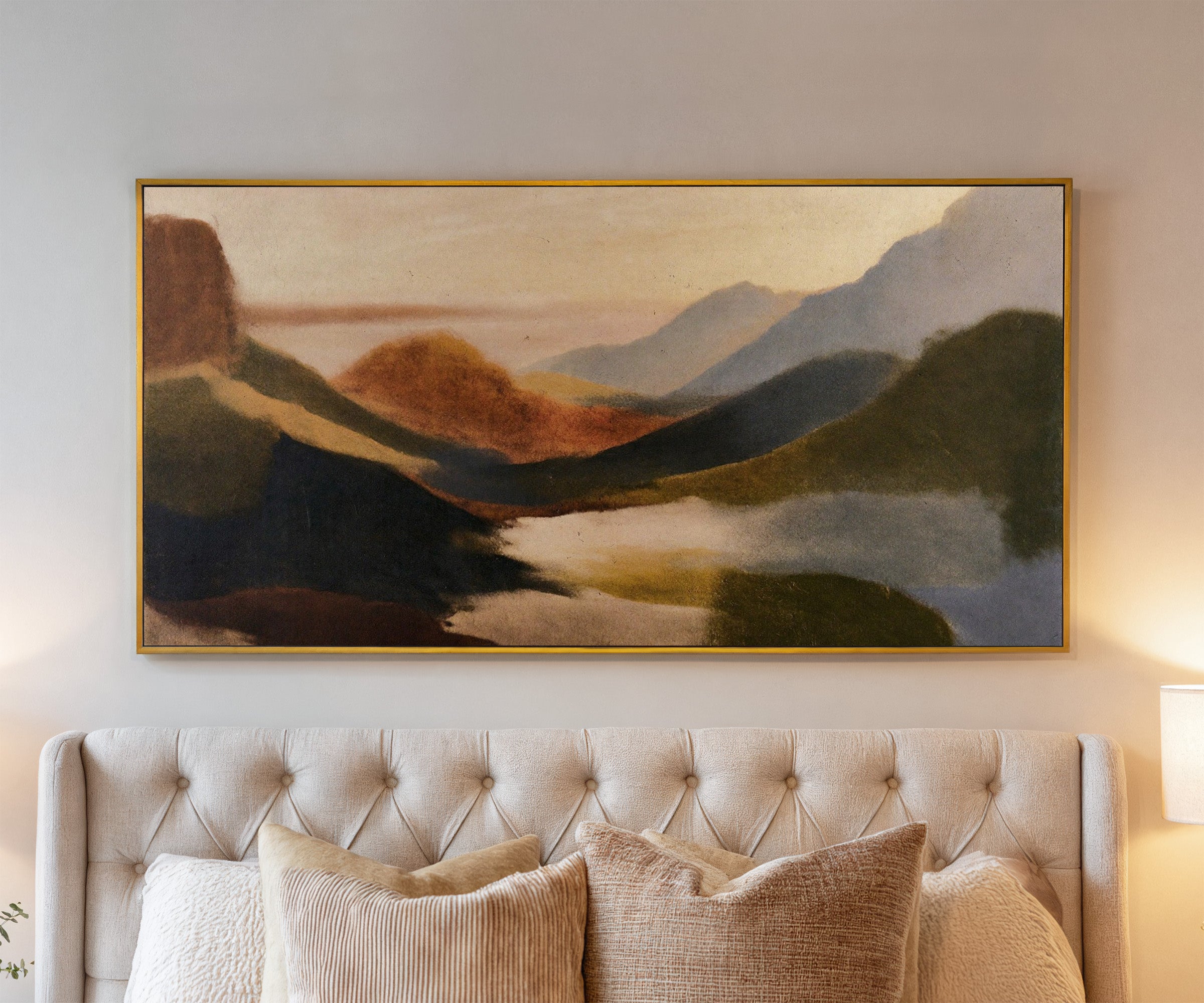 layered coastal landscape with dark headlands, canvas wall art in a gold frame above a bed