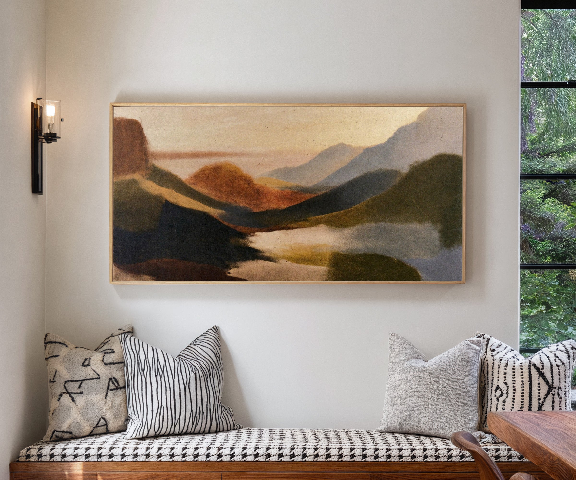 layered coastal landscape with dark headlands, canvas wall art in a natural wood frame in a living room