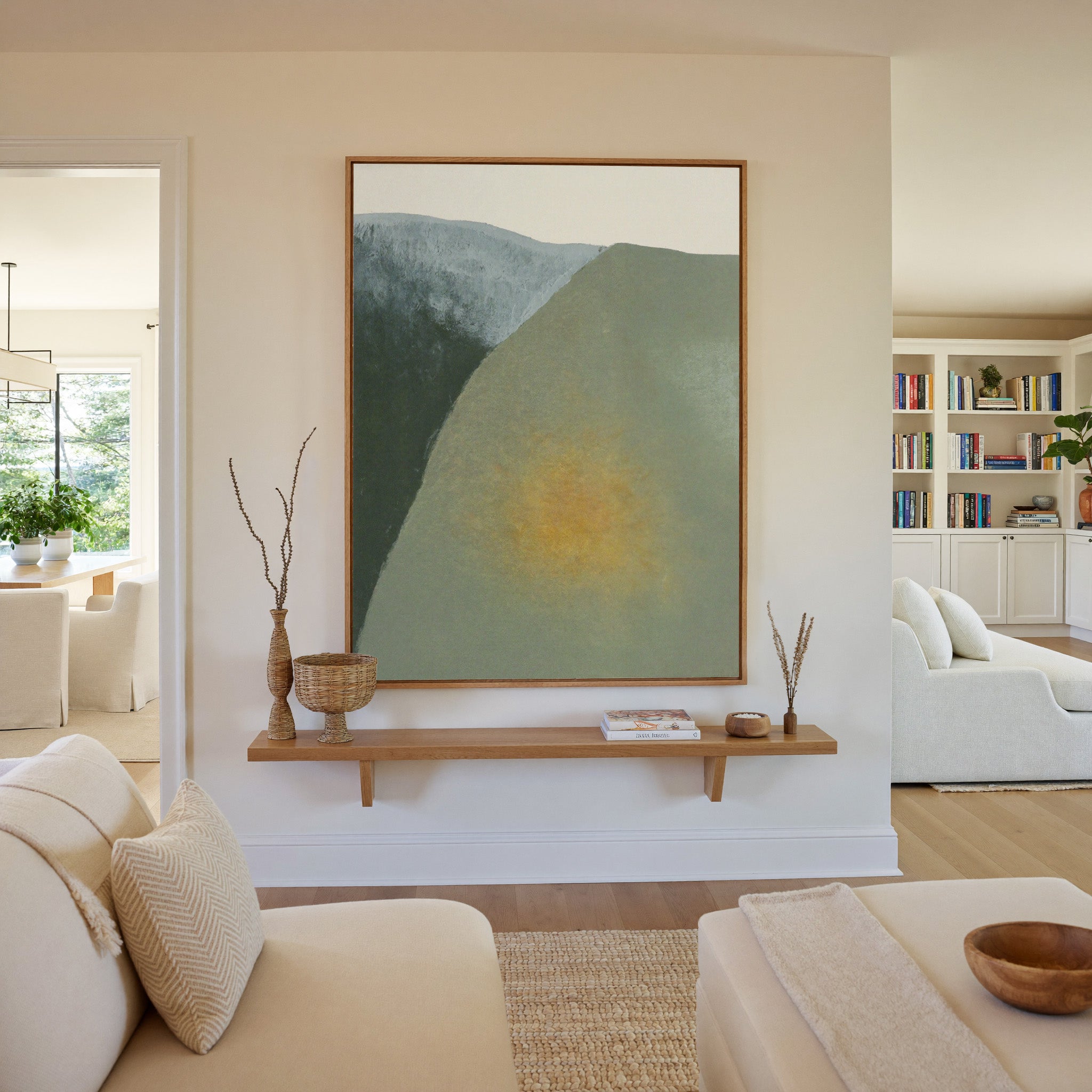 soft olive and charcoal abstract with a warm canvas wall art in an oak frame in a living room
